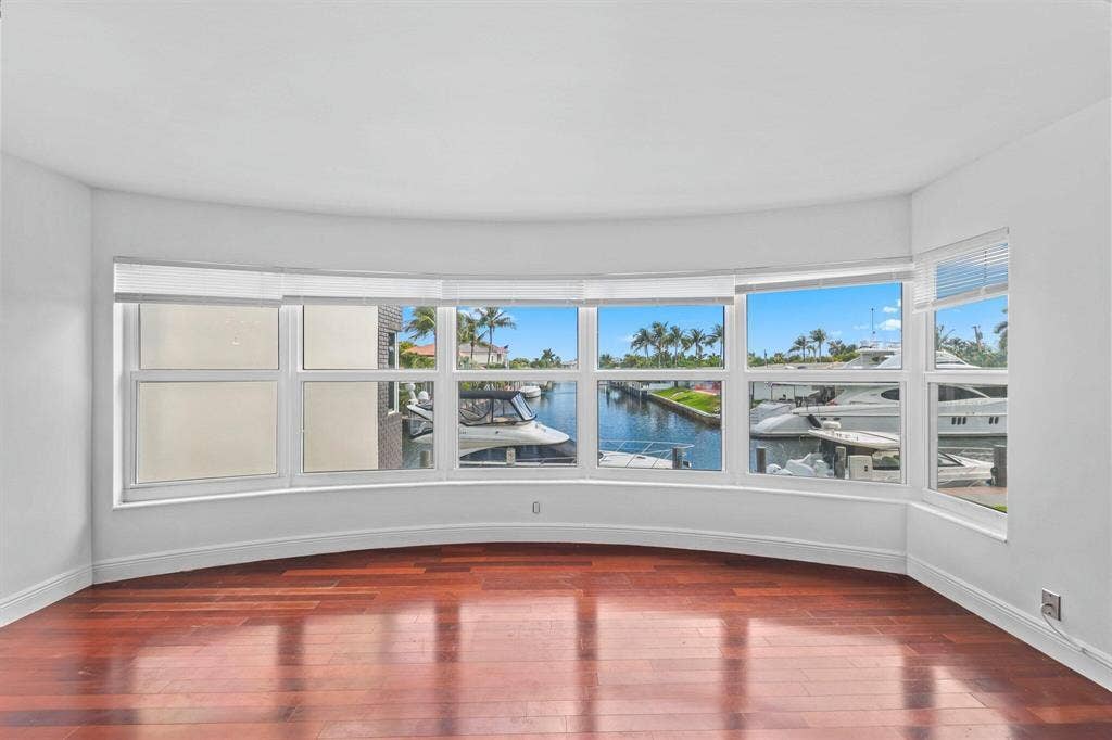 This open concept Living Room, Dining room, Florida Room is very spacious and offers amazing canal views to watch the boats and relax.