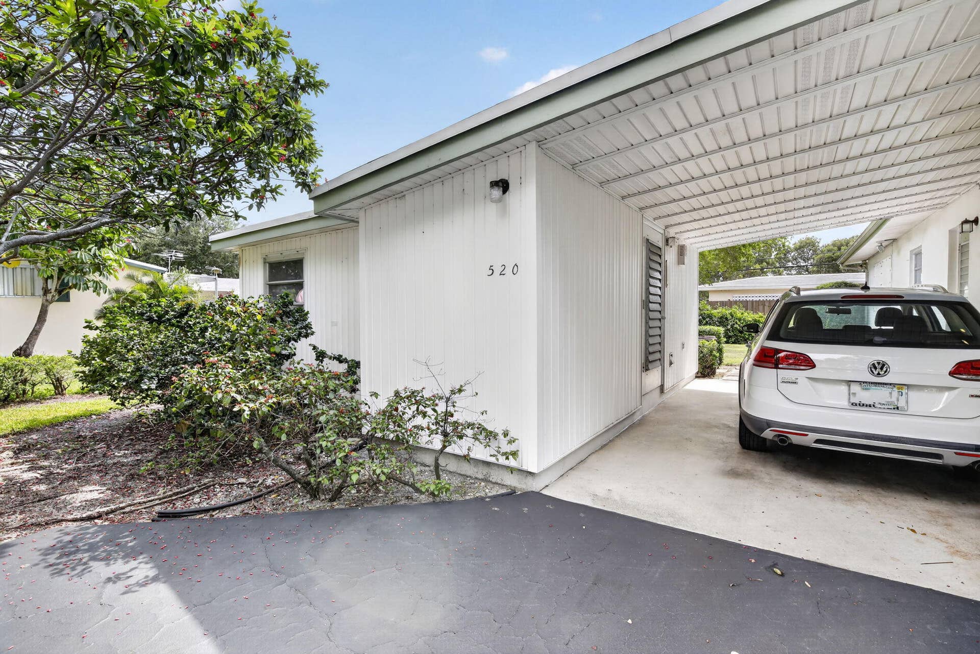 520 BEACHWOOD Lane, Plantation, FL 33317 The Laundry Room is next to the attached carport, to the left.