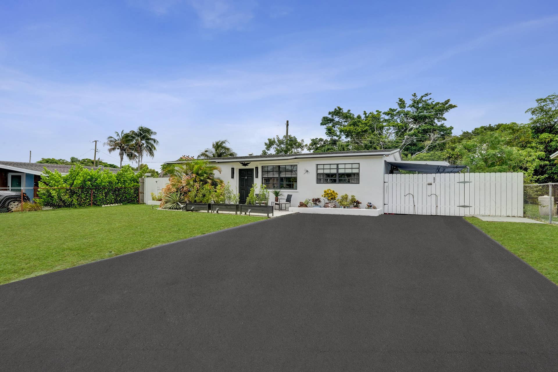 4131 NW 11th Avenue, Fort Lauderdale, FL 33309 driveway -big enough for 4 cars, 1 in carport behind fence