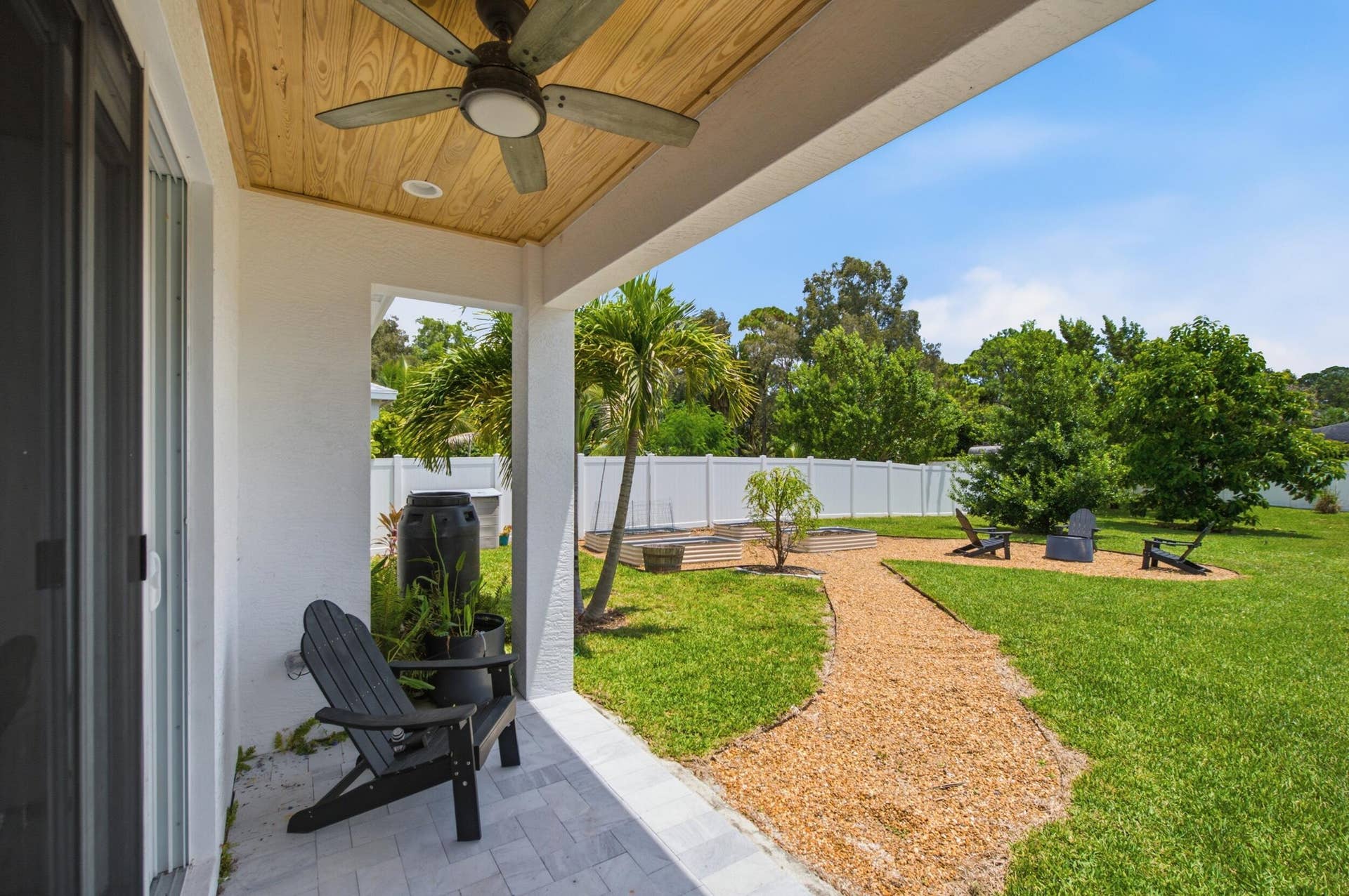 18302 Limestone Creek Road, Jupiter, FL 33458 Enjoy the view of the garden from the cool shade of the back patio.