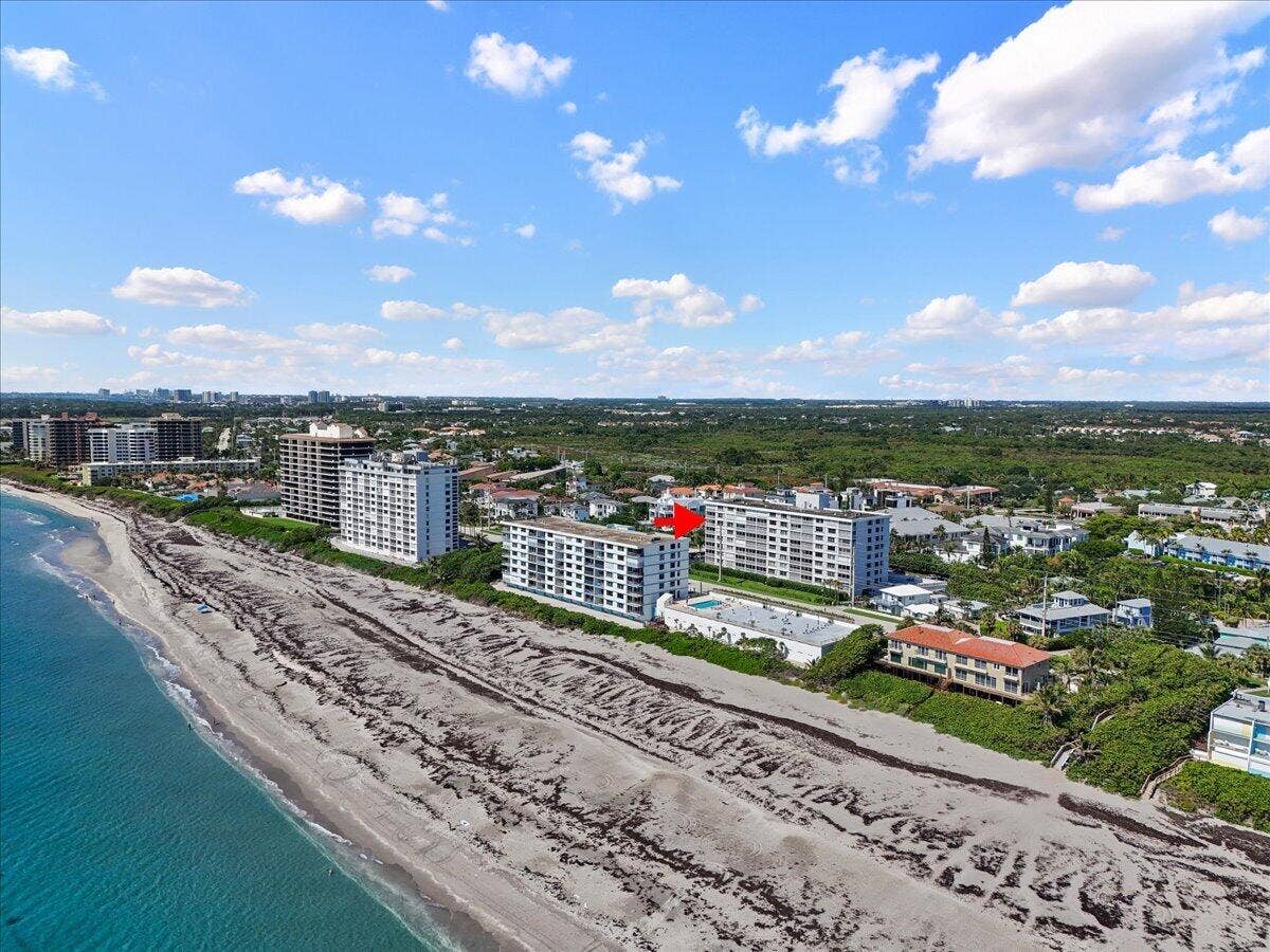 911 Ocean Drive, #601, Juno Beach, FL 33408 Coastal property with direct beach access, surrounded by multiple mid-rise buildings, and backed by extensive green space
