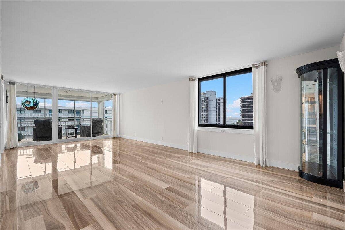 911 Ocean Drive, #601, Juno Beach, FL 33408 Expansive interior with glossy wood-finish flooring, white walls, and a built-in display cabinet