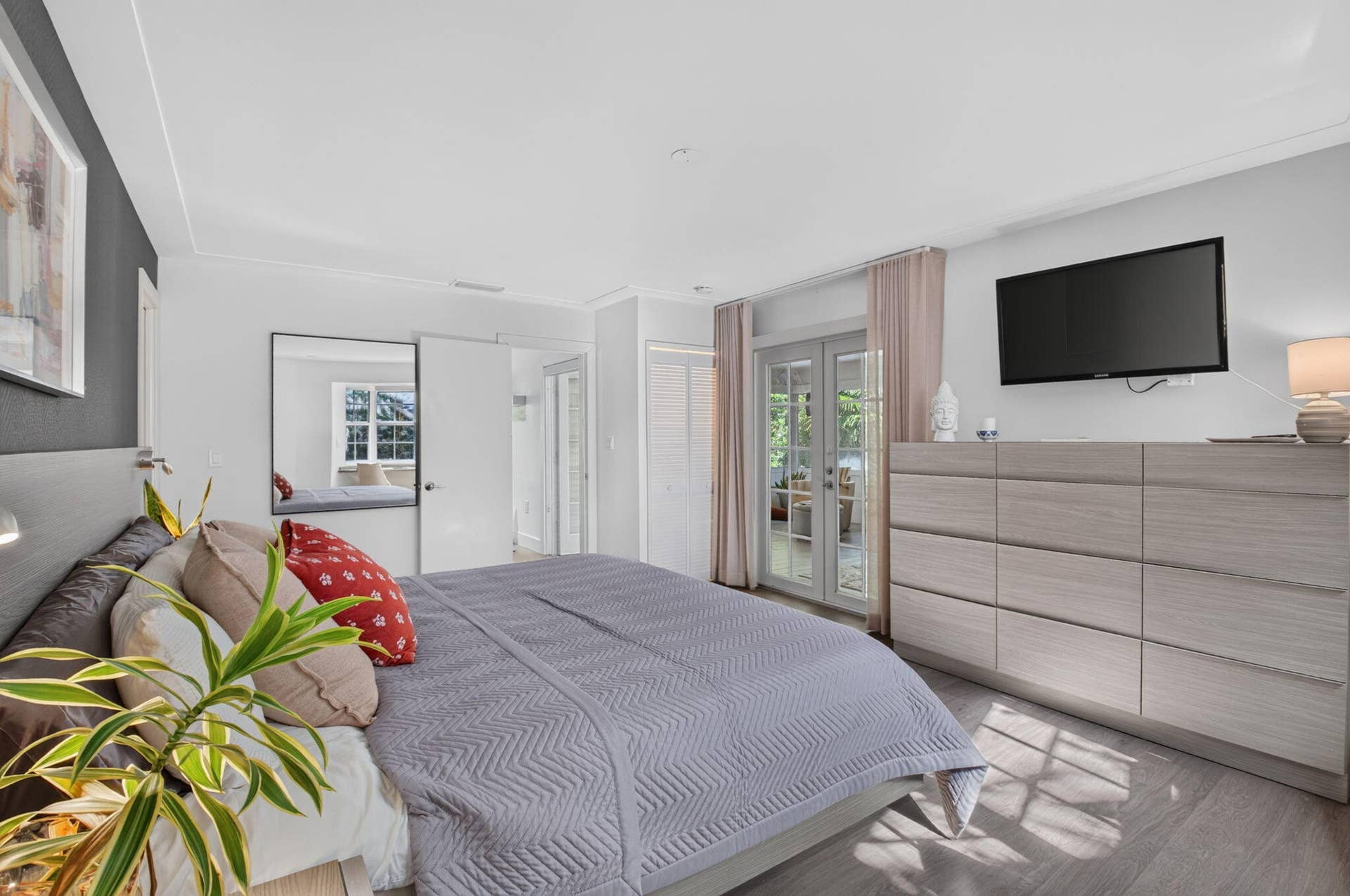 PRIMARY BEDROOM HAS FRENCH DOORS LEADING TO THE SUNROOM....
