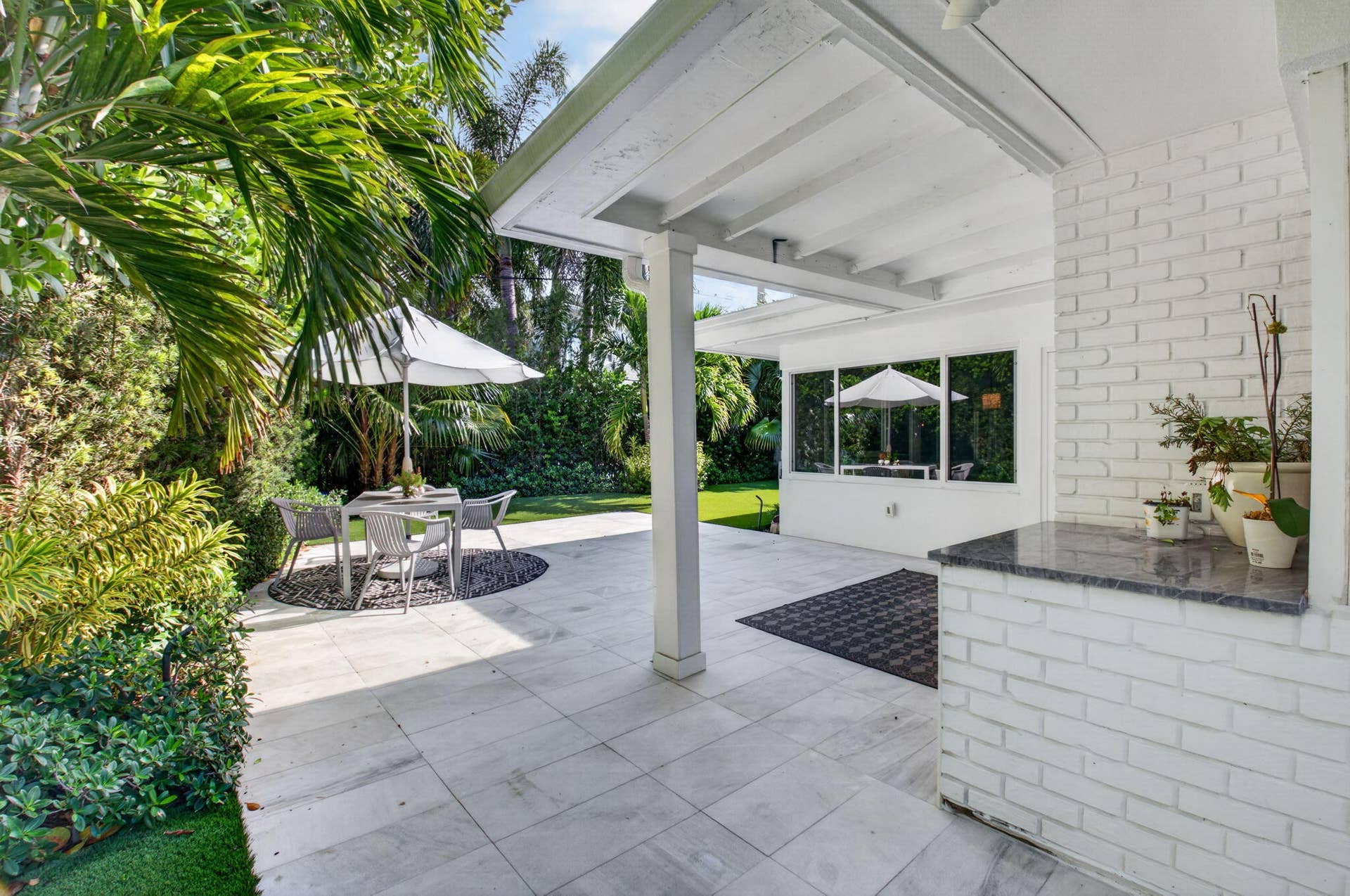 THE COVERED AREA ON THE PATIO IS THE PERFECT SIZE FOR DINING IN ON RAINY DAYS.