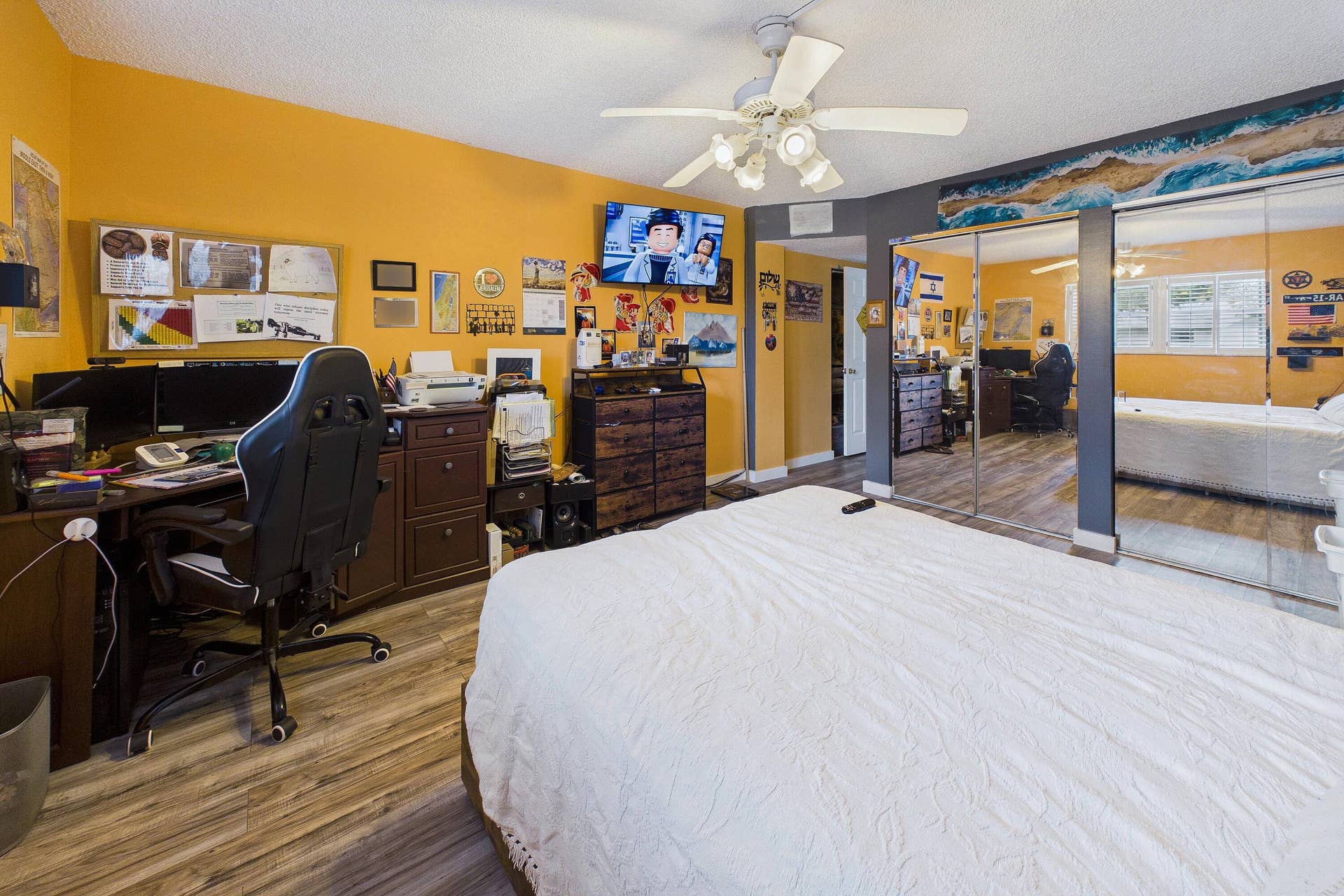 Wood-finish flooring, ceiling fan, mirrored closet doors, and recessed lighting