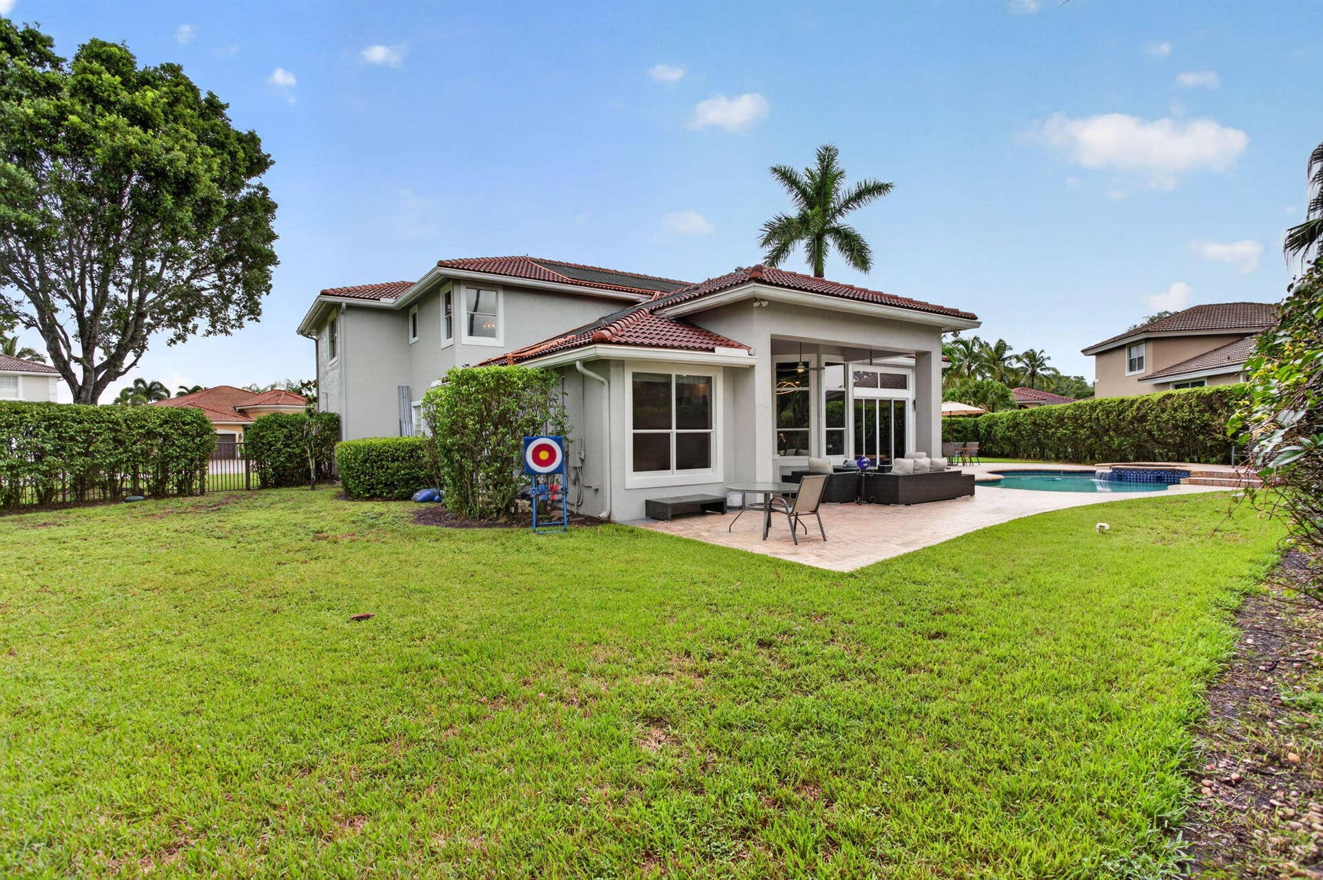 577 NW 120TH Drive, Coral Springs, FL 33071 Situated nearly on a half an acre , this fully fenced yard featuring a solar and gas heated pool, summer kitchen, spa, and yard space for endless activities