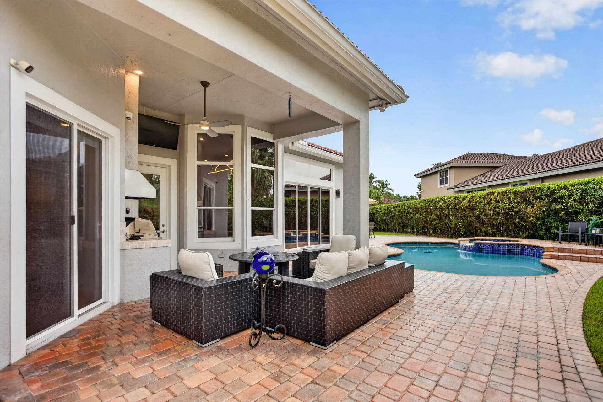 577 NW 120TH Drive, Coral Springs, FL 33071 Situated nearly on a half an acre , this fully fenced yard featuring a solar and gas heated pool, summer kitchen, spa, and yard space for endless activities