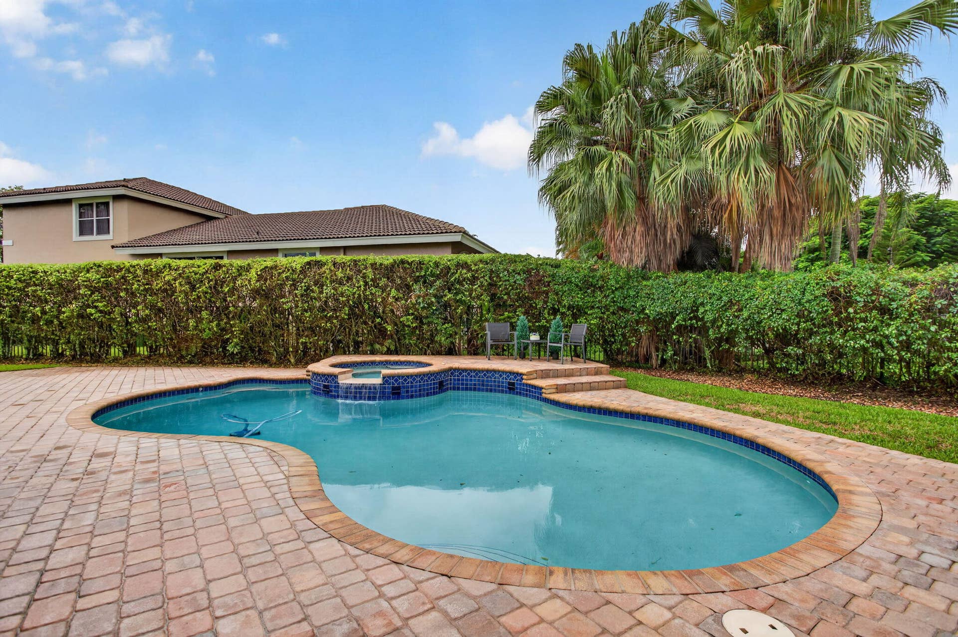 577 NW 120TH Drive, Coral Springs, FL 33071 Situated nearly on a half an acre , this fully fenced yard featuring a solar and gas heated pool, summer kitchen, spa, and yard space for endless activities