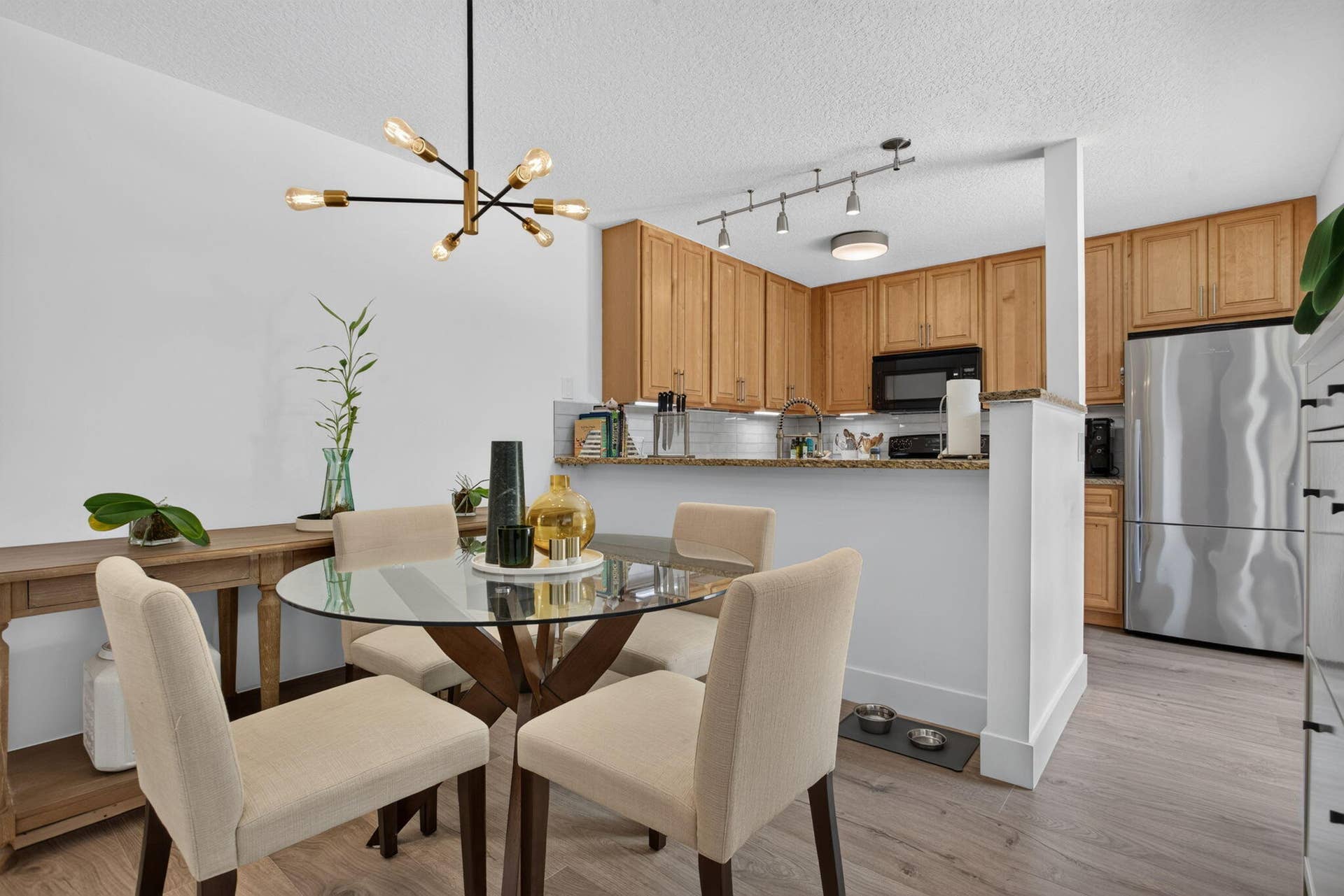 9113 SW 20th Court, #A, Davie, FL 33324 Kitchen and dining area featuring wood-finish flooring, recessed lighting, and a modern chandelier