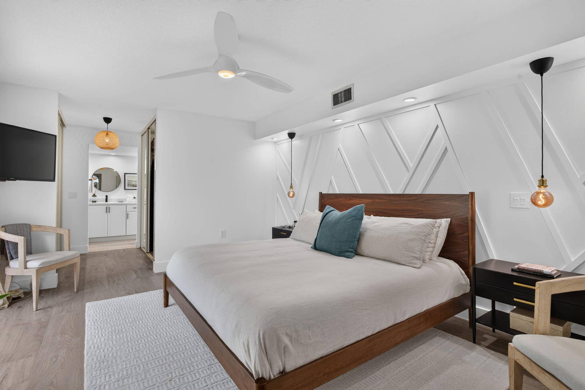 9113 SW 20th Court, #A, Davie, FL 33324 Wood-finish flooring with a white textured accent wall and recessed lighting