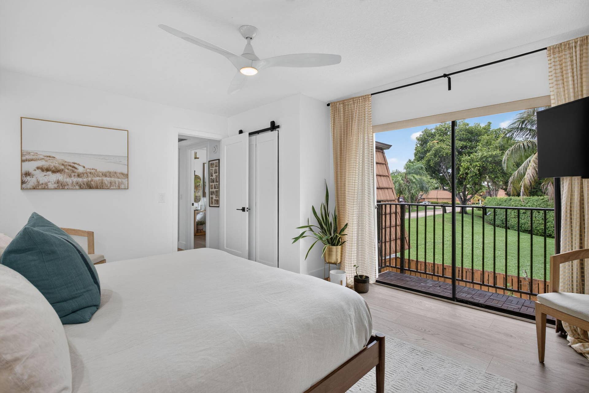 9113 SW 20th Court, #A, Davie, FL 33324 Wood-finish flooring, ceiling fan, and sliding barn door