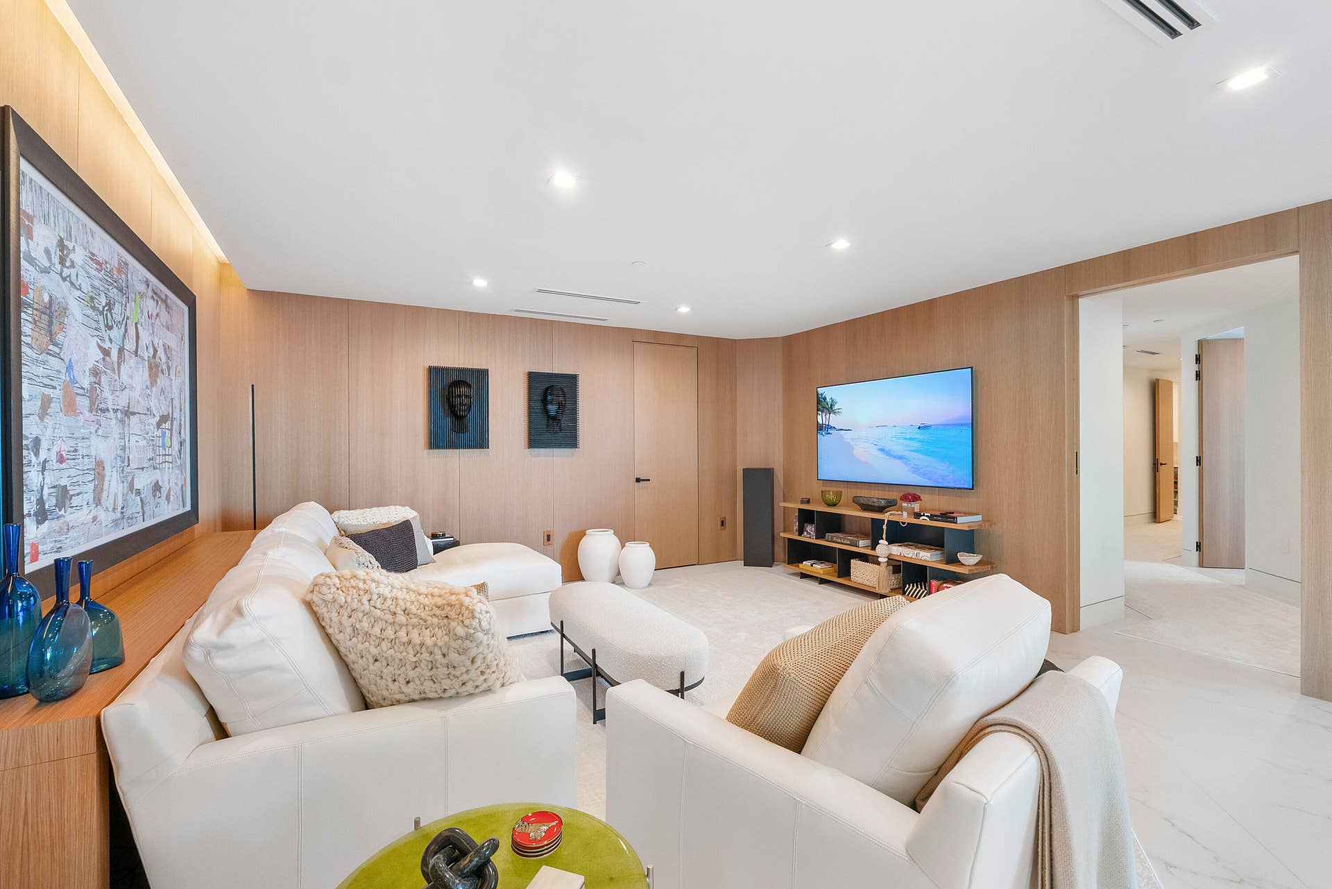 1700 S OCEAN Boulevard, #PH B-D, Lauderdale By The Sea, FL 33062 Bespoke Architecture in Every Direction The beauty of this room is found as much in its architecture as its furnishings. Meticulously crafted white oak wall panels extend uninterrupted around the room, incorporating doors and architectural elements so seamlessly that they virtually disappear into the millwork. Designer gypsum-board ceiling treatments, recessed lighting and softly illuminated perimeter detailing complement the natural oak, giving the entire room the quiet sophistication of a custom-designed private residence. Beyond, the adjoining creative studio can become an extension of the living space or disappear behind its substantial folding doors.