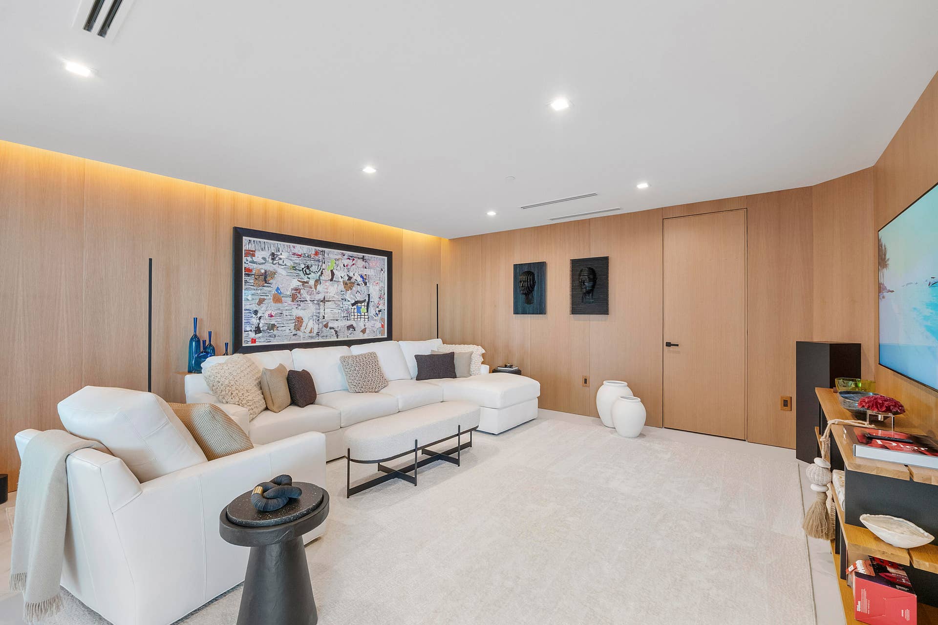 1700 S OCEAN Boulevard, #PH B-D, Lauderdale By The Sea, FL 33062 A Living Room Wrapped in White Oak An extraordinary level of craftsmanship defines this beautifully proportioned private living room, where costly solid white oak architectural wall paneling envelops the space from wall to wall, creating an atmosphere of warmth, serenity and understated European luxury. Concealed architectural lighting washes softly across the oak, while the clean-lined ceiling, designer gypsum-board detailing and pale flooring create a sophisticated contemporary backdrop. More intimate than the penthouse's grand entertaining spaces, this is a luxurious retreat for conversation, reading, movies or simply unwinding in complete privacy.