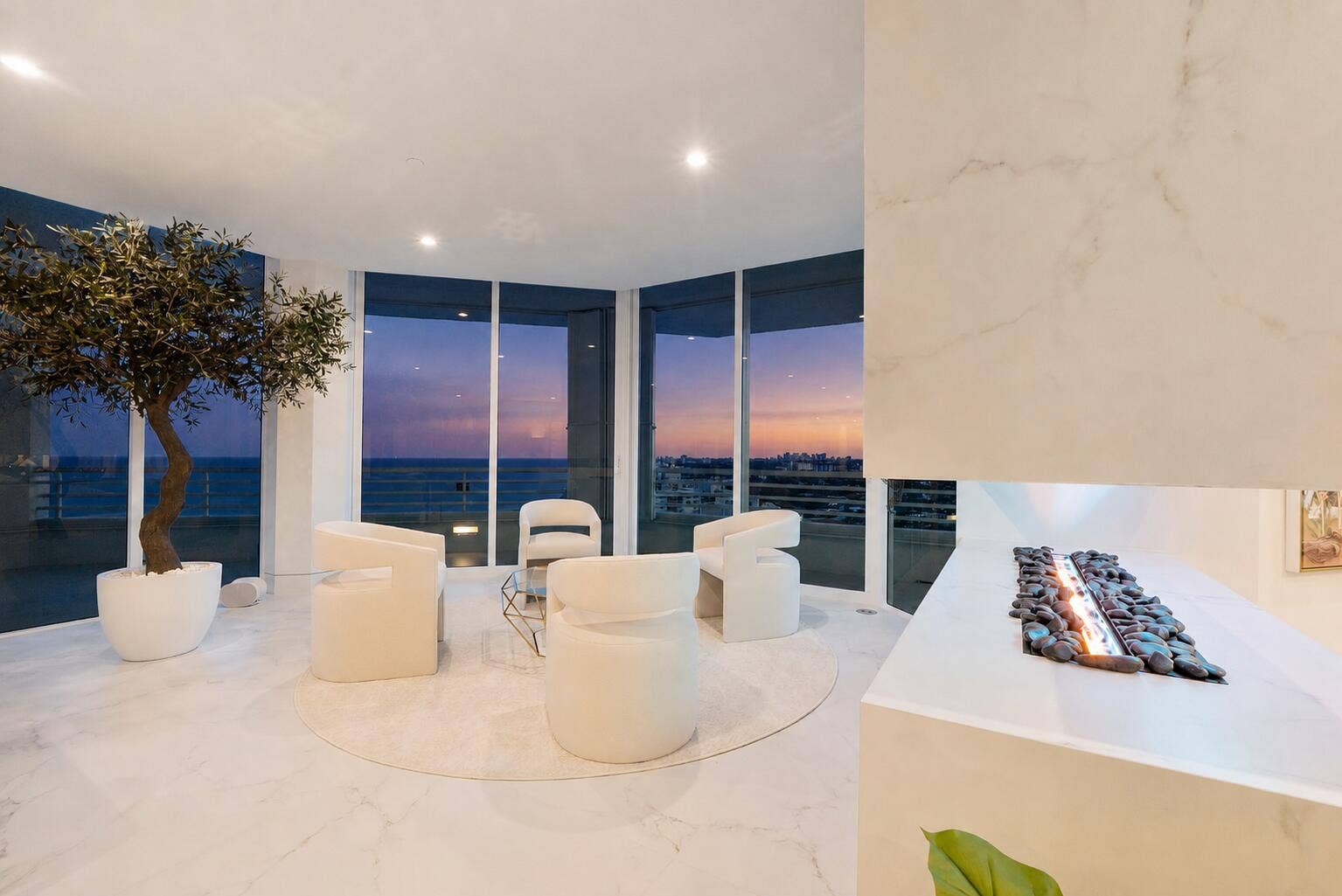 1700 S OCEAN Boulevard, #PH B-D, Lauderdale By The Sea, FL 33062 Capturing sweeping views of the Atlantic Ocean, coastline and distant skyline. The curved glass creates an almost panoramic connection to the horizon, where endless blue water and sky become part of the room itself. Designed as a place to slow down, unwind and simply take in the view, the space is finished with elegant large-format porcelain flooring, softly textured wall treatments and refined architectural detailing. Natural light pours through the glass, while the neutral palette allows the extraordinary ocean backdrop to remain the focal point. Whether enjoying morning coffee as the coastline awakens, settling in with a book, or watching the colors of the sky change at day's end, this South East sitting room offers a remarkable sense of peace, privacy and serenityan elevated sanctuary suspended between sea and sky.