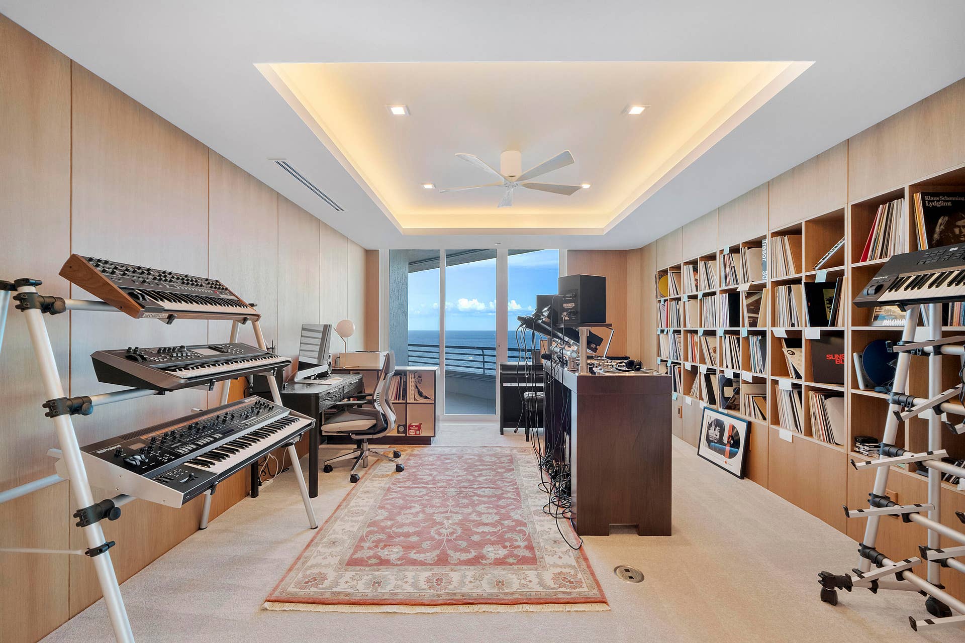1700 S OCEAN Boulevard, #PH B-D, Lauderdale By The Sea, FL 33062 An Oceanfront Studio for the Creative Mind Originally conceived as a bedroom and transformed into a dedicated music and recording environment, this remarkable room offers a rare amenity for the musician, composer, producer, singer-songwriter, podcaster or broadcaster. Acoustically considered walls, designer gypsum-board construction and extensive white oak architectural paneling create a refined setting for recording and production, while integrated shelving provides extraordinary storage for vinyl, music collections, books and equipment. Above, the dramatic cove-lit tray ceiling gives the studio architectural presence normally reserved for the penthouse's primary entertaining rooms.