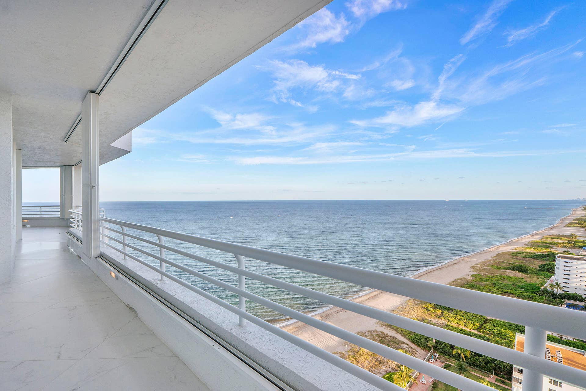 1700 S OCEAN Boulevard, #PH B-D, Lauderdale By The Sea, FL 33062 Looking south down the beach, the clouds are white and the sky compliments the ocean of sapphire