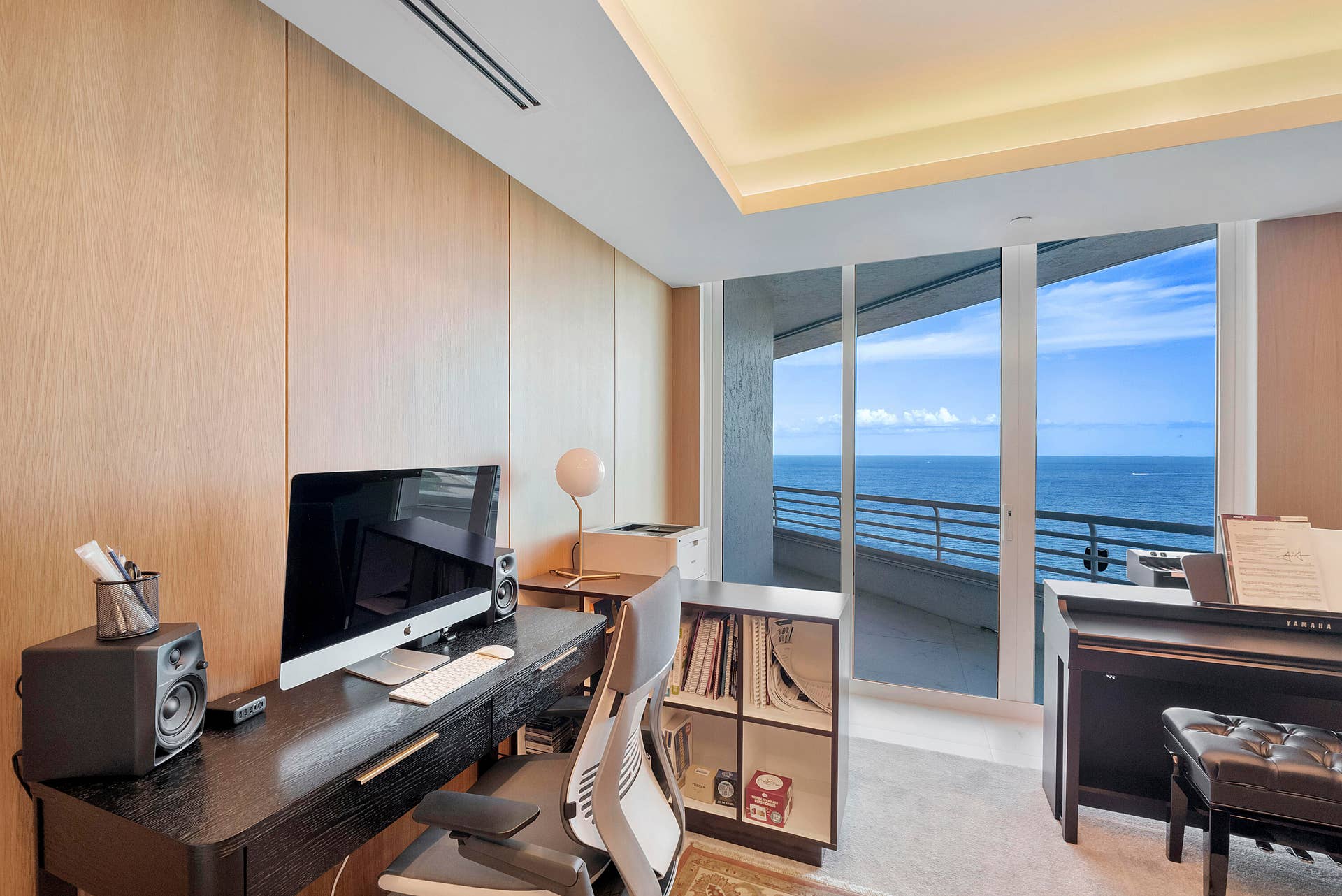 1700 S OCEAN Boulevard, #PH B-D, Lauderdale By The Sea, FL 33062 A Room Designed to Become Whatever Inspires You While currently arranged as an impressive music and production studio, this oceanfront room offers exceptional flexibility. It could become a private podcast or broadcast studio, songwriter's retreat, painting atelier, writer's room, executive office, screening room, library, meditation studio or luxurious additional bedroom suite. The adjoining white-oak-paneled living room provides valuable space for collaborators, guests or a production team, while the solid white oak folding doors allow the two rooms to function independently whenever privacy is required. With its glowing tray ceiling and balcony opening directly toward the Atlantic, even the workspace enjoys a spectacular connection to the ocean.
