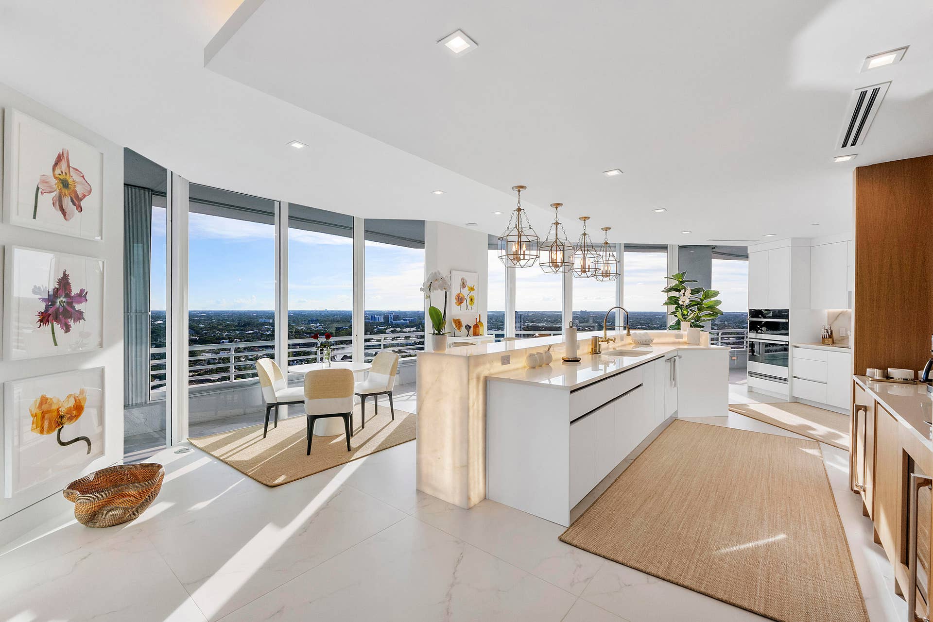 1700 S OCEAN Boulevard, #PH B-D, Lauderdale By The Sea, FL 33062 Masterfully designed by internationally acclaimed designer Alessandro Potenti, this extraordinary chef's kitchen showcases stunning backlit Cristallo natural stone, illuminated to mirror the warm glow of the spectacular western sunsets. A dedicated tea & coffee island creates an elegant caf-inspired retreat, while the oversized island, custom cabinetry, and state-of-the-art appliances blend seamlessly with the home's sophisticated contemporary design. Wrapped in walls of glass, this remarkable space enjoys endless panoramic views stretching across the Intracoastal Waterway, Broward County, and all the way to the Everglades, creating one of the most breathtaking culinary settings on Florida's Gold Coast.