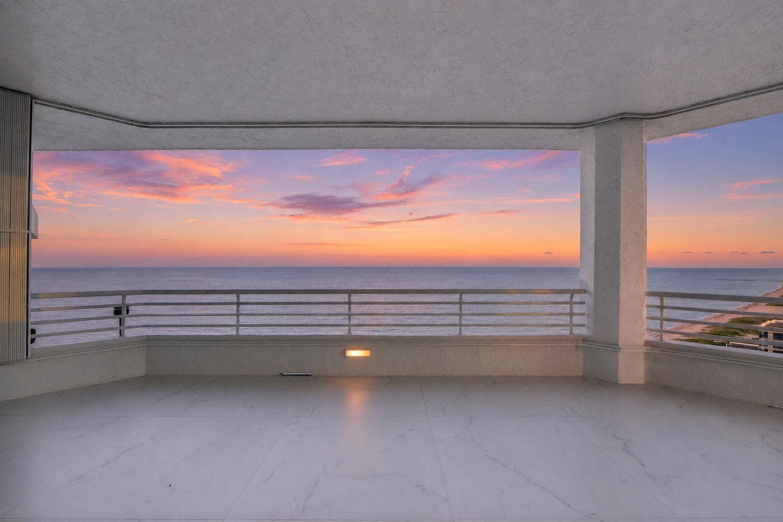 1700 S OCEAN Boulevard, #PH B-D, Lauderdale By The Sea, FL 33062 With approximately 1,600 square feet of European porcelain-clad balconies surrounding the residence, there is an extraordinary sense of living both above the ocean and beneath the open sky. By day, brilliant turquoise ocean views fill the residence with light. By evening, the floor-to-ceiling glass captures the golden glow of sunset as the skyline begins to sparkle in the distance.