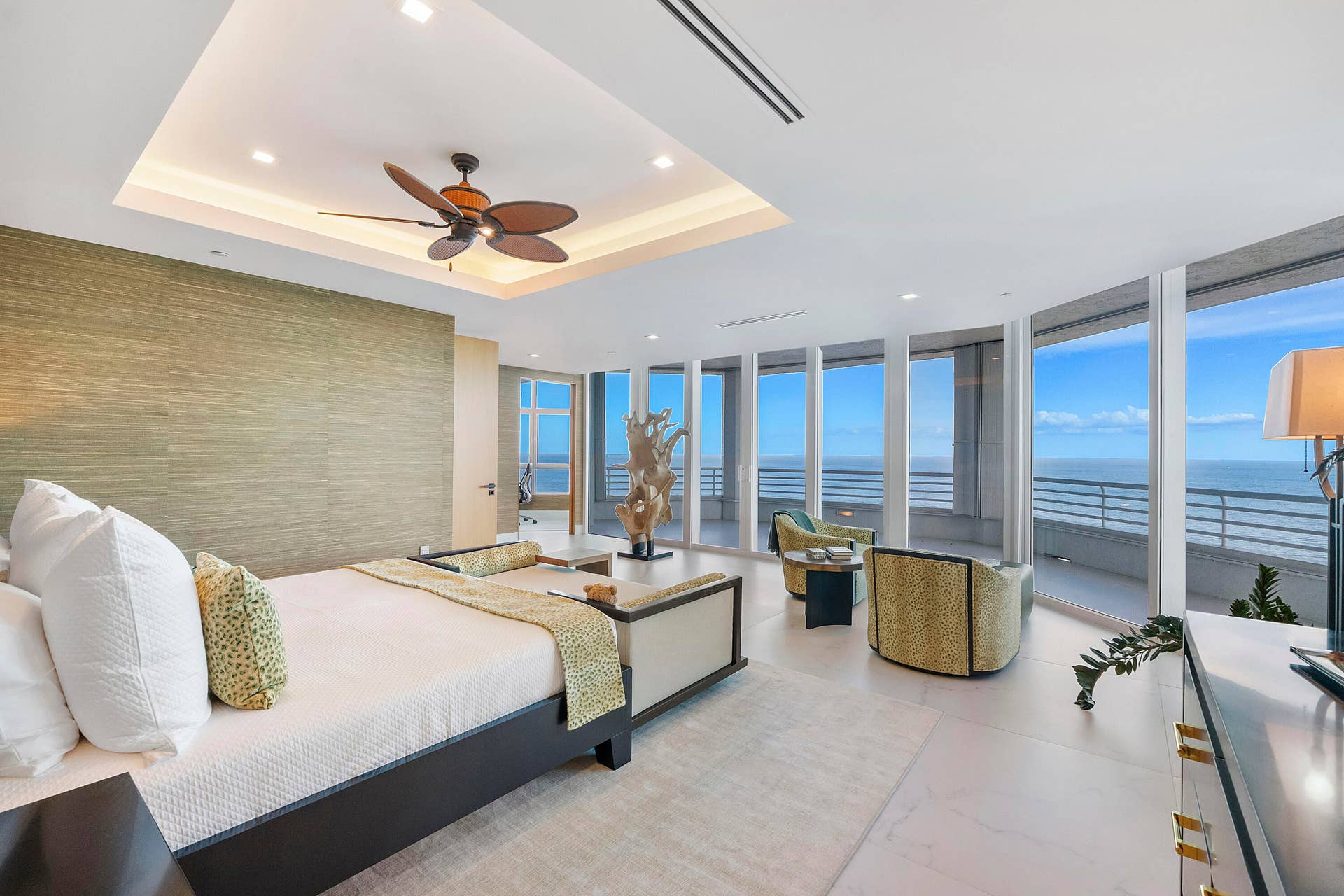 1700 S OCEAN Boulevard, #PH B-D, Lauderdale By The Sea, FL 33062 A dramatic freestanding wood sculpture adds an artistic focal point to the primary suite, where its organic form is framed by floor-to-ceiling glass and the ever-changing colors of the ocean and sky.