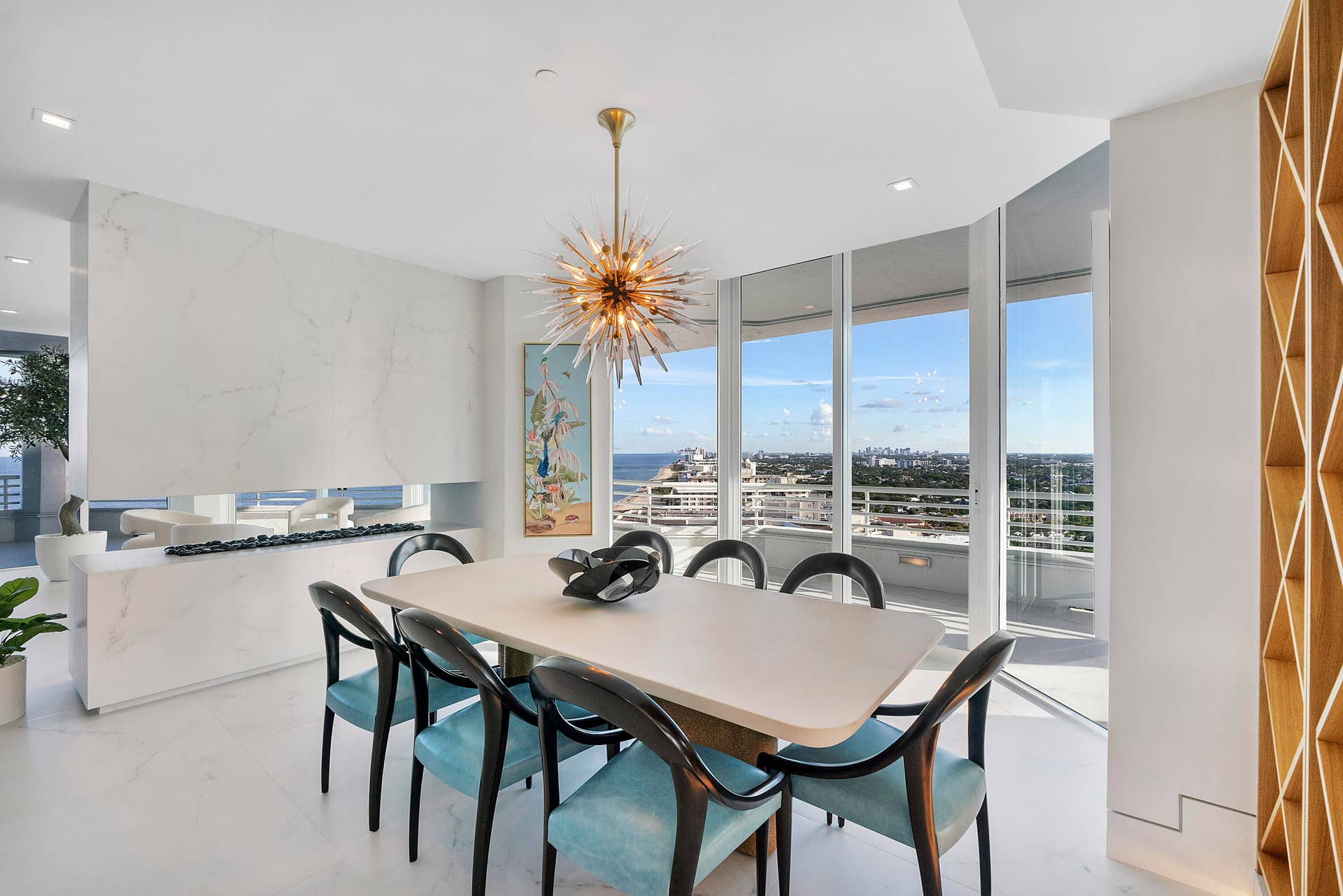 1700 S OCEAN Boulevard, #PH B-D, Lauderdale By The Sea, FL 33062 Personally designed by internationally acclaimed designer Alessandro Potenti, this breathtaking formal dining room showcases panoramic Atlantic Ocean and Intracoastal views, a dramatic porcelain fireplace with a glowing golden flame, and exquisite designer lighting for an unforgettable dining experience.