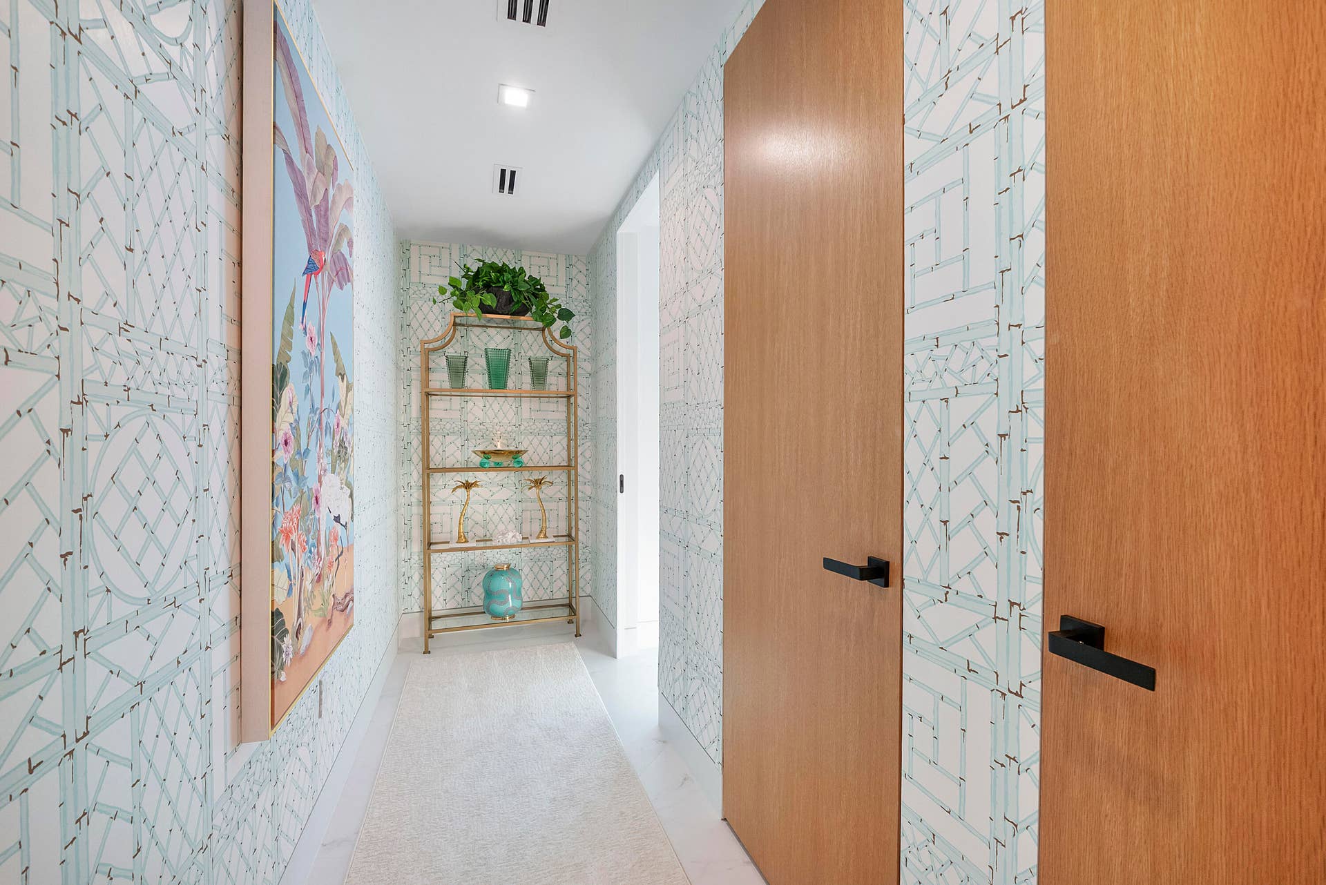 1700 S OCEAN Boulevard, #PH B-D, Lauderdale By The Sea, FL 33062 A Private Passage to the Aqua Guest Wing Tucked away on the penthouses west side, a long private gallery hallway creates a wonderful sense of arrival and separation before reaching the Aqua Guest Wing. Designer wall coverings in delicate aqua tones, curated artwork and warm natural-wood doors transform the passage into an elegant transition, beautifully distancing this suite from the Primary Suite and other guest accommodations. It is this thoughtful separation that gives visiting family or guests the wonderful feeling of having their own private wing within the penthouse.