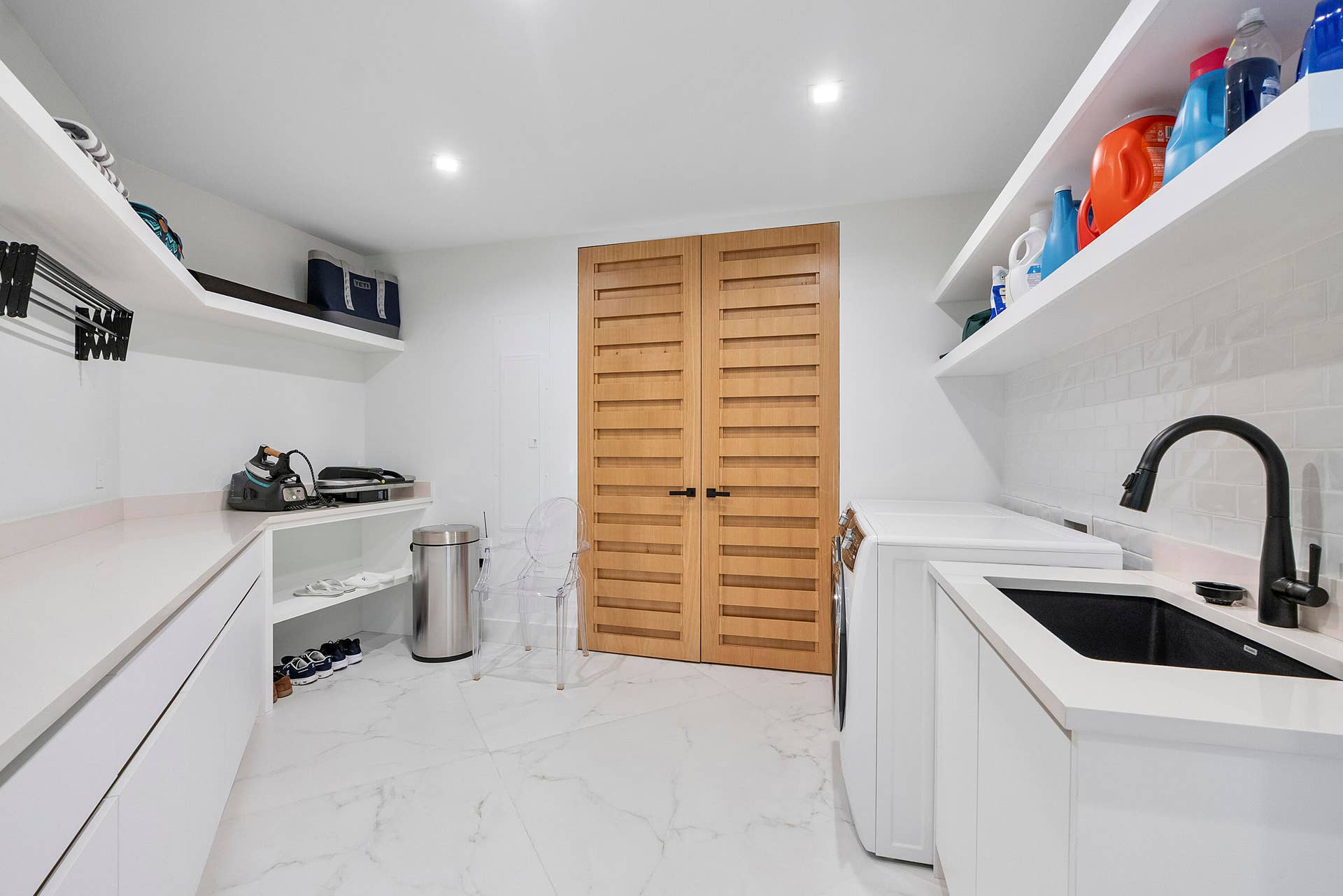 1700 S OCEAN Boulevard, #PH B-D, Lauderdale By The Sea, FL 33062 Even the laundry room has been designed on a grand scale. This exceptionally spacious laundry and garment-care suite combines beautiful design with extraordinary functionality, featuring a full-size washer and dryer, deep utility sink, generous countertops and an abundance of custom cabinetry and storage. A dedicated pressing and steaming area provides the perfect setting for caring for fine clothing and linens, while cleverly concealed utility closets keep vacuums, mops and household essentials completely out of sight. Extensive shelving provides room for everything from freshly folded linens and towels to luggage and household supplies.