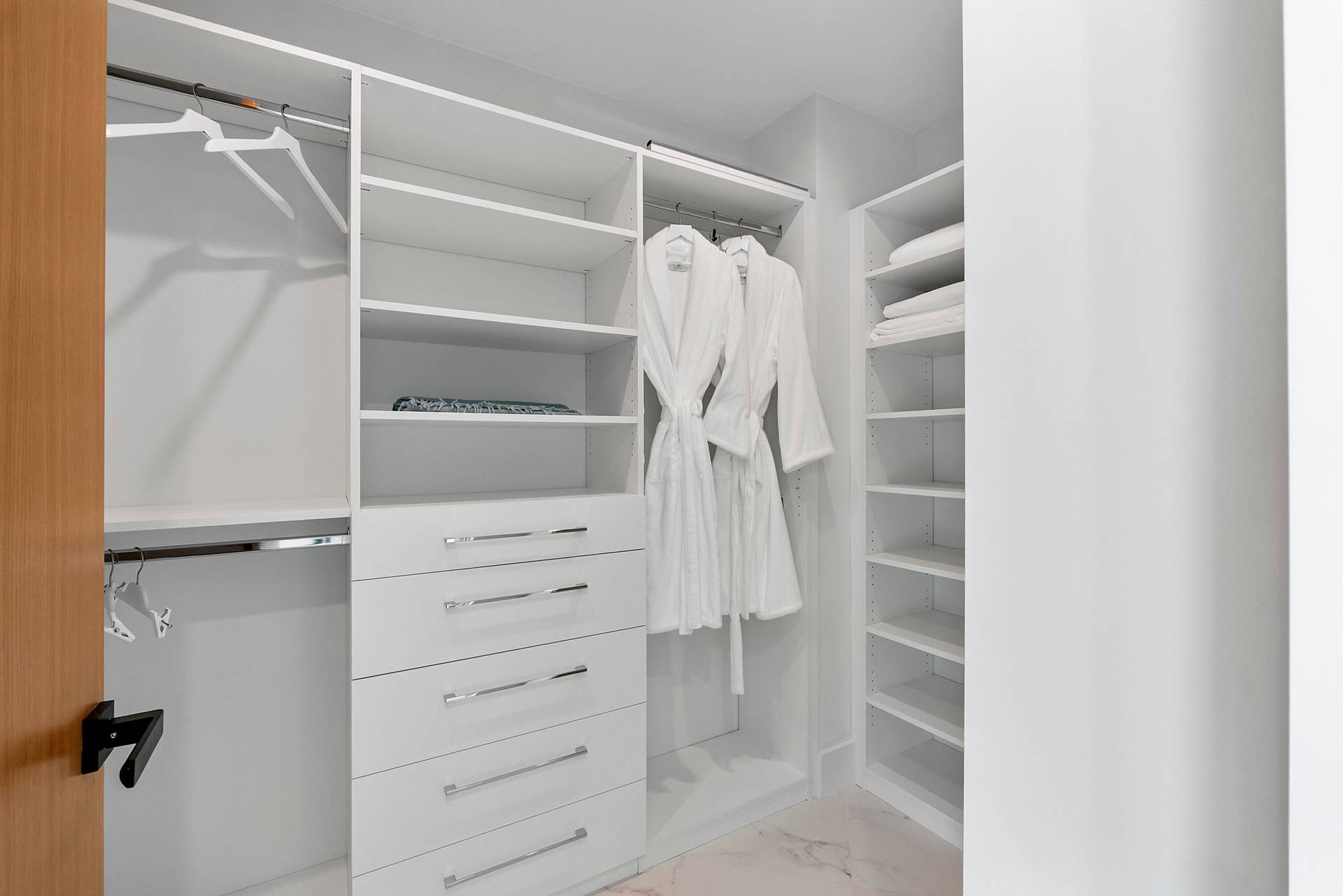 1700 S OCEAN Boulevard, #PH B-D, Lauderdale By The Sea, FL 33062 A Boutique-Style Private Dressing Room The Aqua Guest Wing includes its own beautifully fitted walk-in dressing room, with extensive custom shelving, drawers and hanging space designed to accommodate far more than an overnight visit. Guests can unpack completely, organize luggage and clothing, and make the suite genuinely their ownan especially thoughtful luxury for extended family, children returning home, grandchildren or long-stay houseguests.