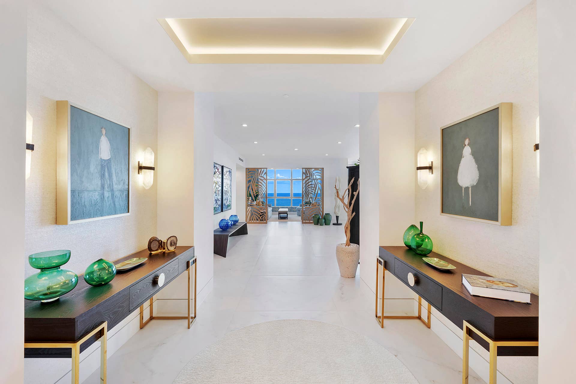 1700 S OCEAN Boulevard, #PH B-D, Lauderdale By The Sea, FL 33062 Step through the grand double-door entry into a breathtaking gallery-inspired foyer, where perfectly balanced symmetry creates an immediate sense of elegance and refinement. Matching designer console tables, contemporary artwork, sculptural lighting, and curated dcor frame the entrance, naturally drawing your eye through the home's signature Garden Room to the endless sapphire-blue waters of the Atlantic Ocean. This thoughtfully designed architectural axis creates an unforgettable first impression, setting the stage for the extraordinary residence beyond. Every designer furnishing, curated work of art, custom lighting fixture, and decorative accessory has been meticulously selected and is included, offering a truly turnkey luxury lifestyle.