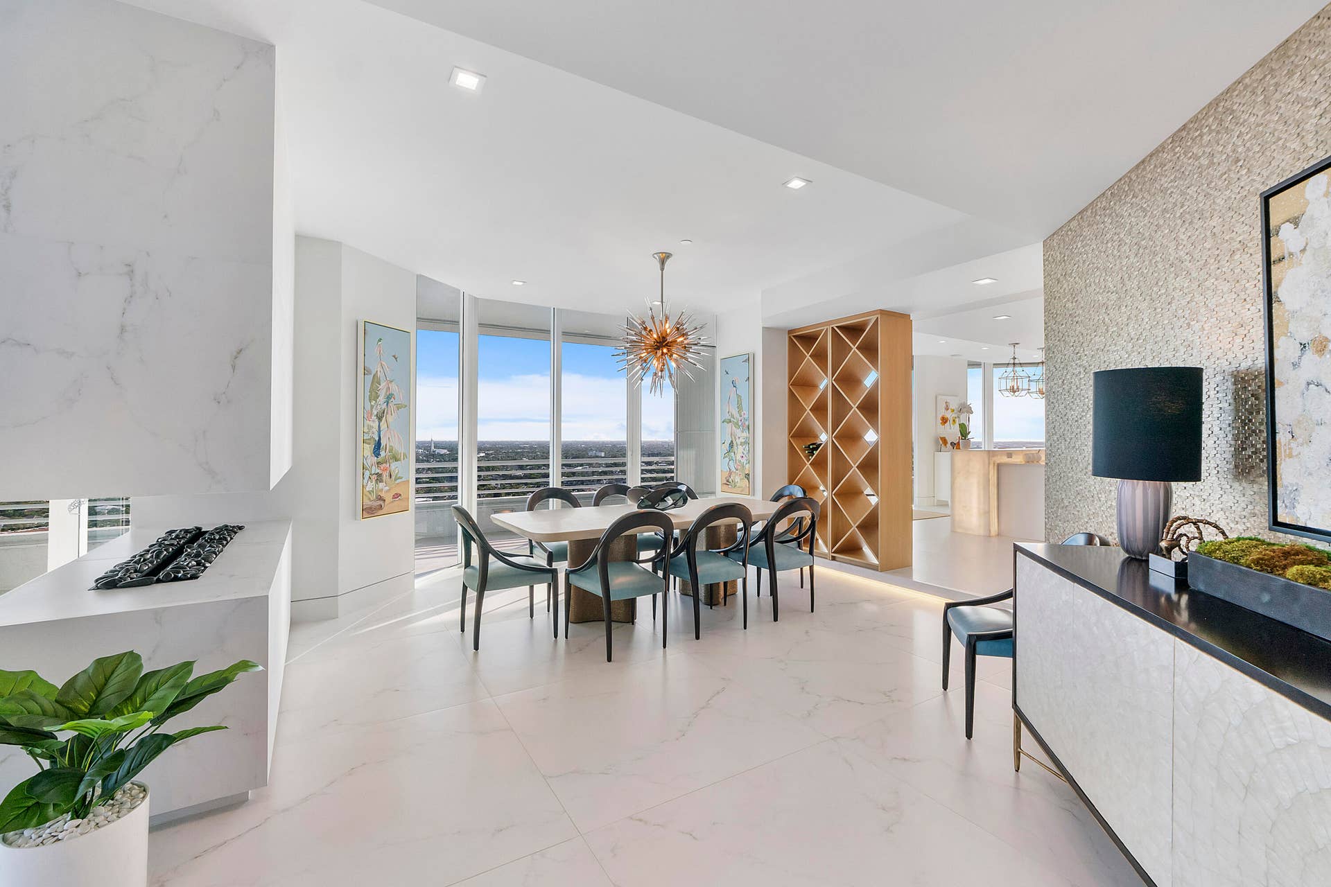 1700 S OCEAN Boulevard, #PH B-D, Lauderdale By The Sea, FL 33062 The formal dining room is perfectly positioned to capture breathtaking panoramic western views across the Intracoastal Waterway and all of Broward County. Floor-to-ceiling walls of glass frame an ever-changing landscape where luxury yachts gracefully cruise by, while endless vistas stretch for miles to the distant Everglades. As the sun begins to set, the sky transforms into a spectacular canvas of vibrant colors, creating an unforgettable backdrop for elegant dining and entertaining. This extraordinary setting offers a rare combination of sparkling waterfront yachting, expansive city views, and Florida's most captivating sunsets.