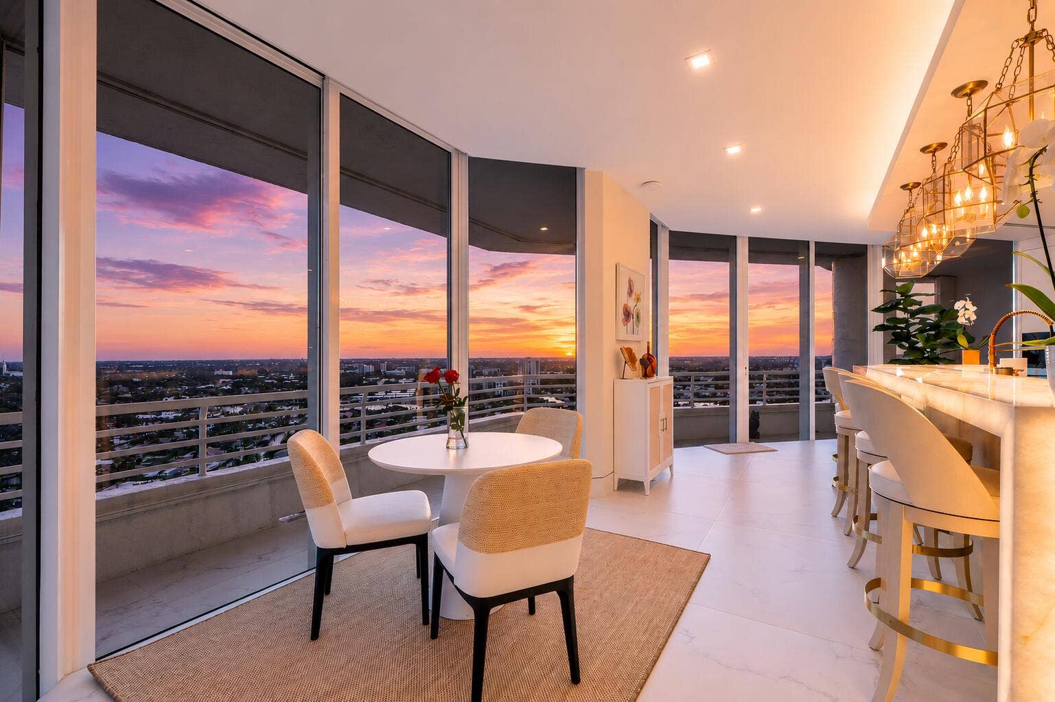 1700 S OCEAN Boulevard, #PH B-D, Lauderdale By The Sea, FL 33062 High above the coastline, evenings become an experience of their ownchampagne on the terrace, warm ocean breezes and a spectacular sunset stretching for miles across the horizon. With approximately 1,600 square feet of European porcelain-clad balconies surrounding the residence, there is an extraordinary sense of living both above the ocean and beneath the open sky. By day, brilliant turquoise ocean views fill the residence with light. By evening, the floor-to-ceiling glass captures the golden glow of sunset as the skyline begins to sparkle in the distance.