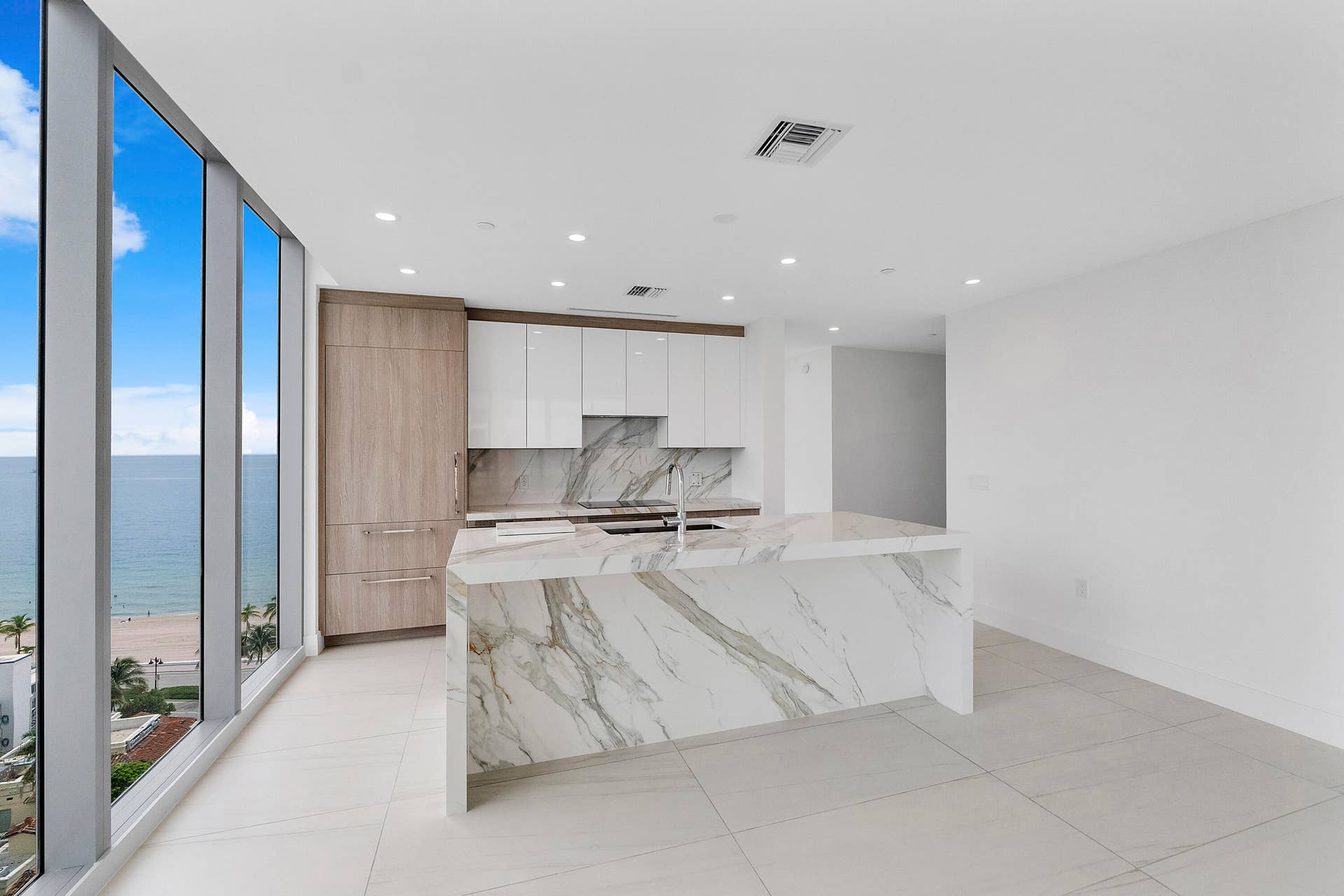 This 10th floor custom designer unit has never been lived in,Updated European porcelain kitchen island and backsplash, Brianna soft close cabinets, Italian porcelain 48 inch flooring