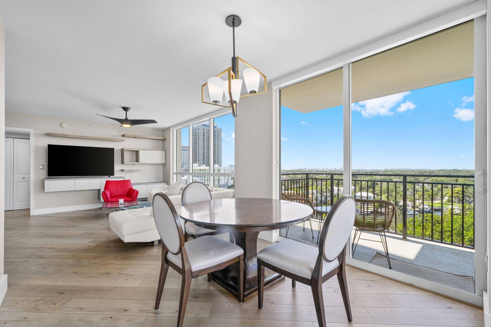 600 W LAS OLAS Boulevard, #902S, Fort Lauderdale, FL 33312 Dining area set beside expansive sliding glass doors, creating a seamless indoor-outdoor connection to the wraparound terrace and surrounding views.
