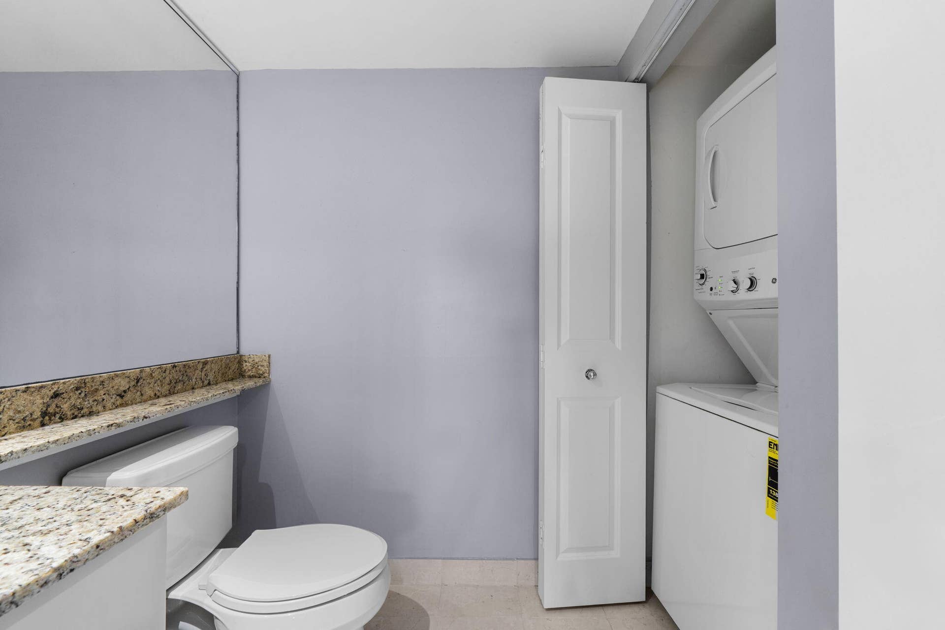 600 W LAS OLAS Boulevard, #902S, Fort Lauderdale, FL 33312 Alternate view of the powder room showing the granite counter, mirrored wall & adjacent in-unit laundry closet.