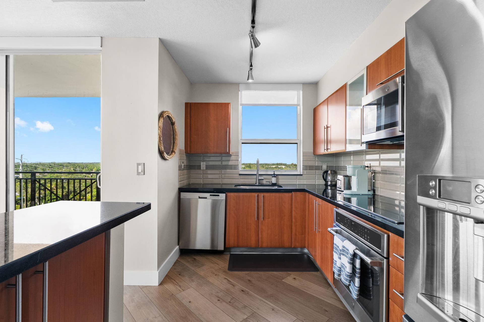 600 W LAS OLAS Boulevard, #902S, Fort Lauderdale, FL 33312 Alternate kitchen view showcasing generous cabinetry, stainless steel appliances, window over the sink & direct terrace access.