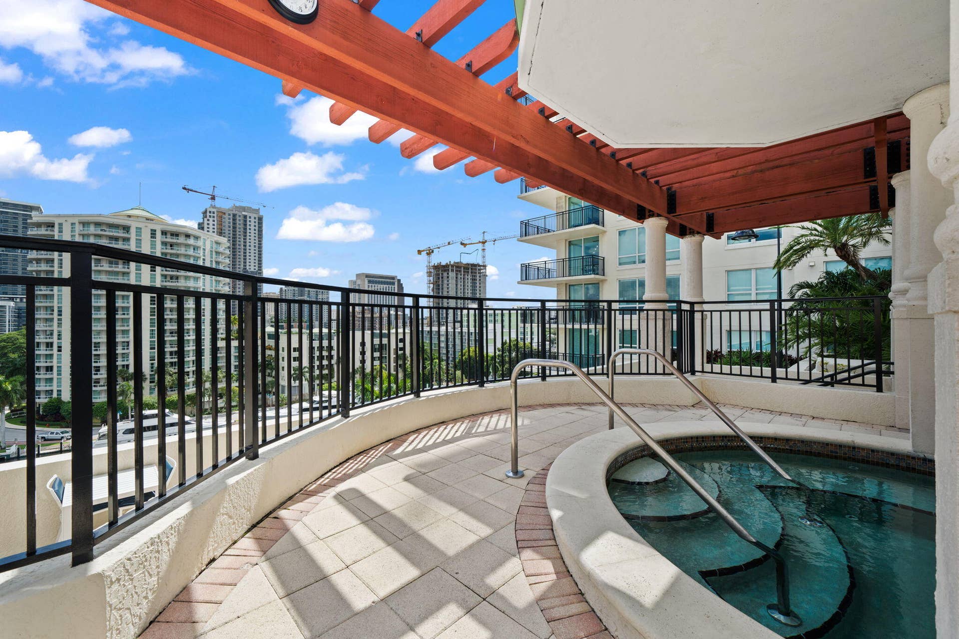 600 W LAS OLAS Boulevard, #902S, Fort Lauderdale, FL 33312 Outdoor hot tub set beneath a pergola, offering a relaxing retreat with surrounding skyline views.
