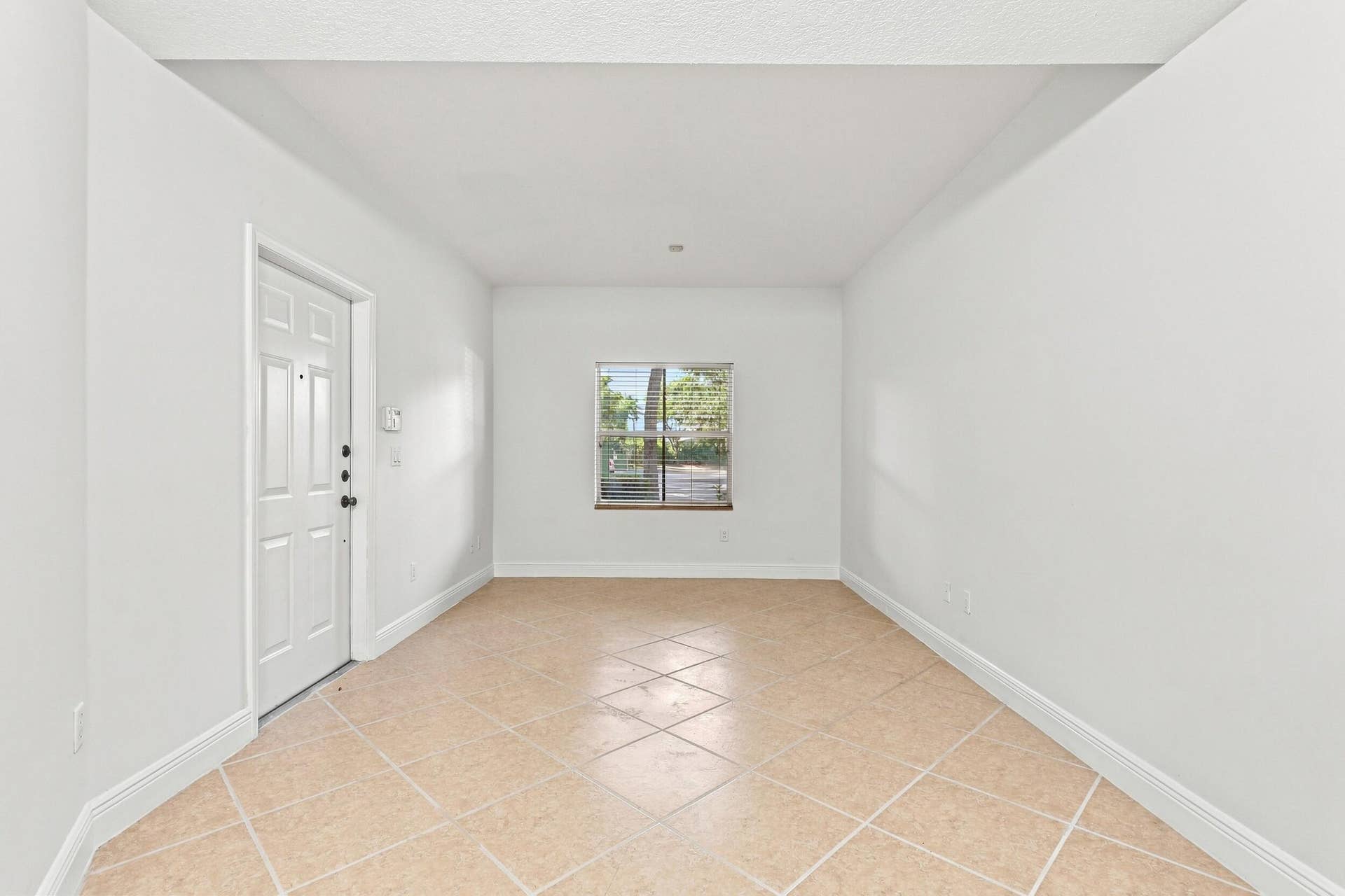 2107 Anchor Court, Fort Lauderdale, FL 33312 Spacious living room with tile flooring, high ceilings, abundant natural light, and an open layout that flows seamlessly into the dining area and kitchen.