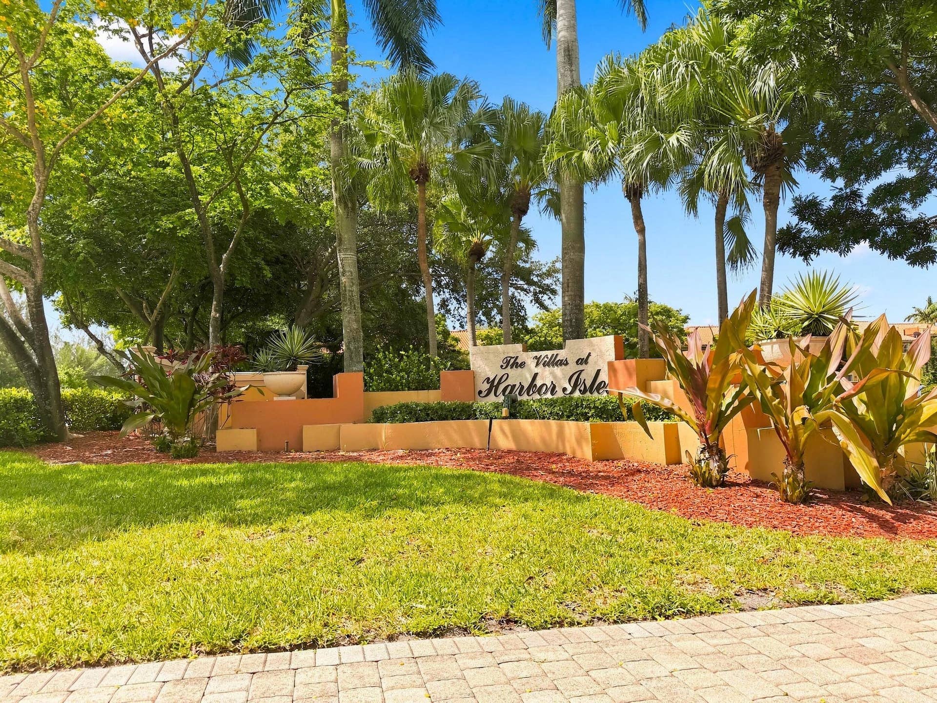 2107 Anchor Court, Fort Lauderdale, FL 33312 A beautifully landscaped community surrounded by mature tropical foliage, offering an inviting South Florida setting with a community pool, playground, and well-maintained common areas.