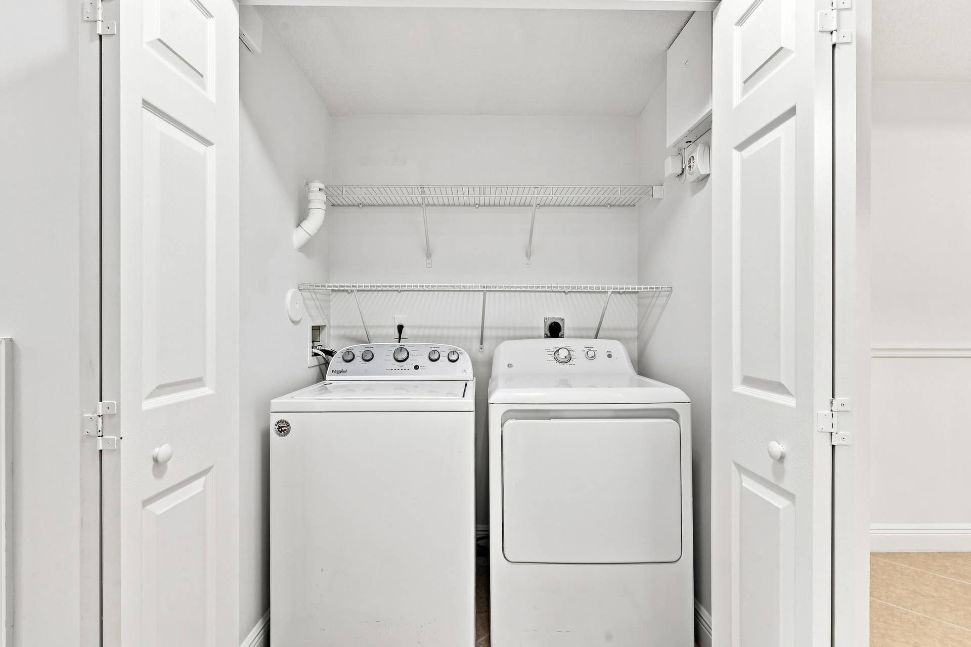 2107 Anchor Court, Fort Lauderdale, FL 33312 Convenient in-home laundry closet with full-size washer and dryer, plus built-in shelving for additional storage.