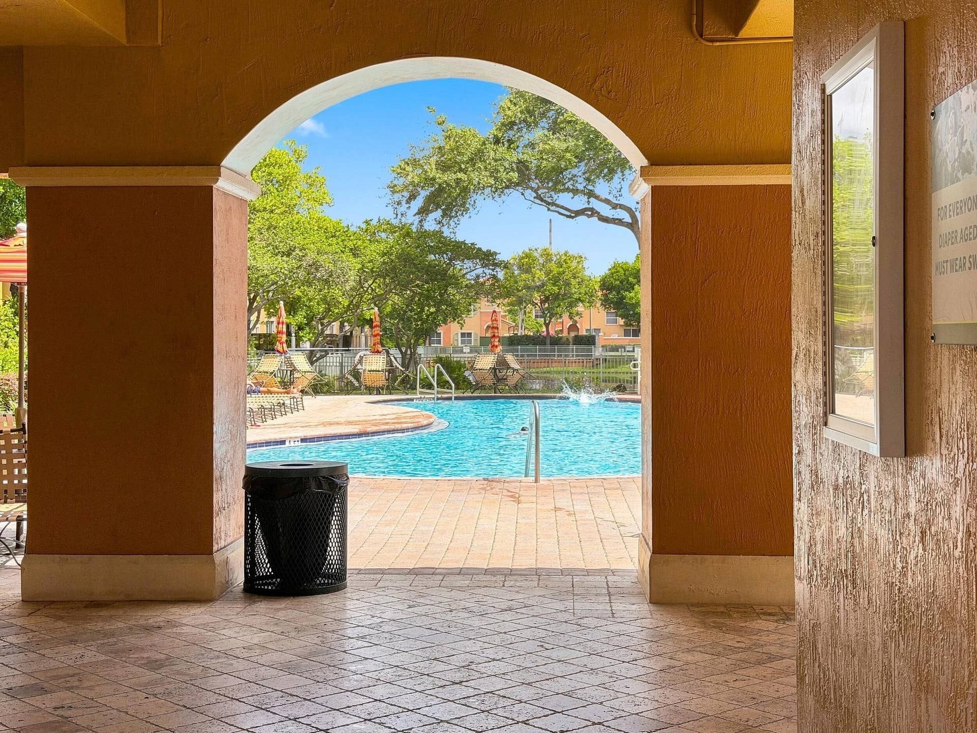 2107 Anchor Court, Fort Lauderdale, FL 33312 Resort-style community pool surrounded by tropical landscaping with spacious poolside seating and shaded areas for relaxing and enjoying the South Florida lifestyle.