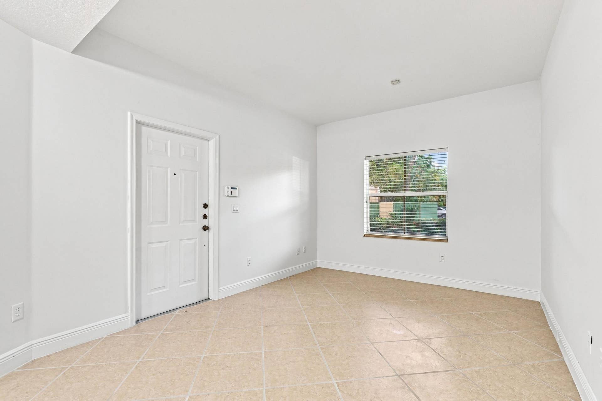 2107 Anchor Court, Fort Lauderdale, FL 33312 Spacious living room with tile flooring, high ceilings, abundant natural light, and an open layout that flows seamlessly into the dining area and kitchen.