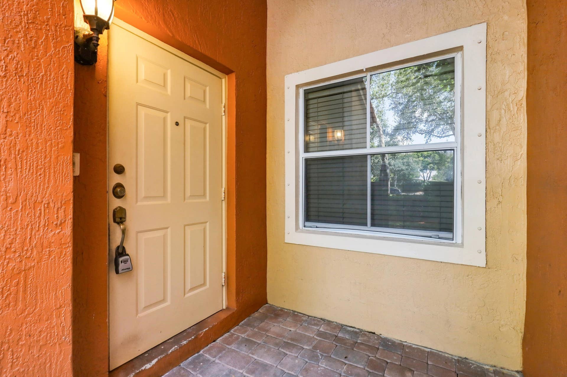 2107 Anchor Court, Fort Lauderdale, FL 33312 Welcoming private covered entry with a paver walkway, gated approach, and sheltered front door offering an inviting transition into the home.