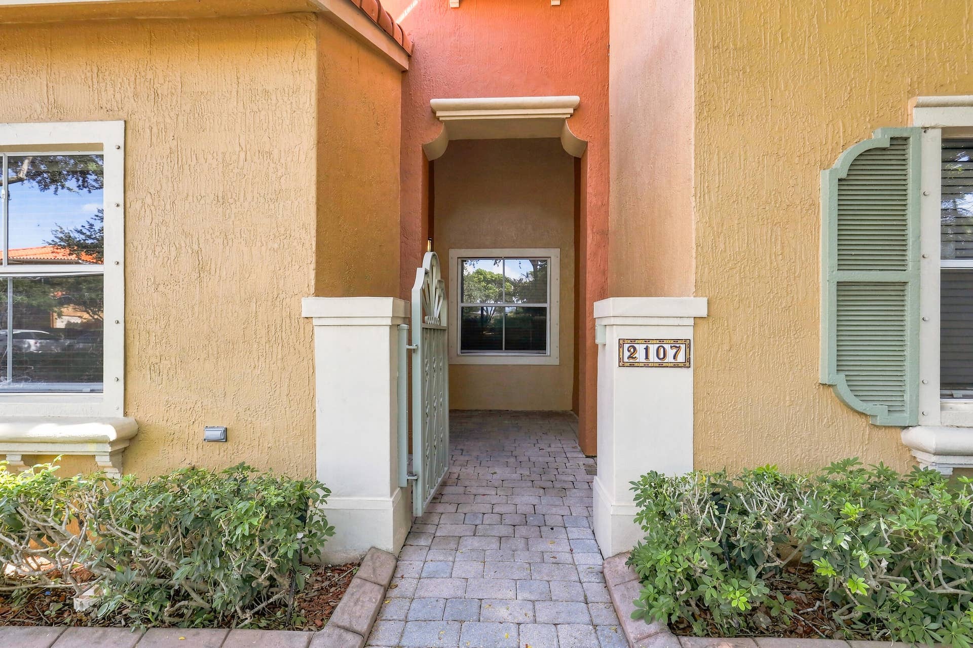2107 Anchor Court, Fort Lauderdale, FL 33312 Welcoming private covered entry with a paver walkway, gated approach, and sheltered front door offering an inviting transition into the home.