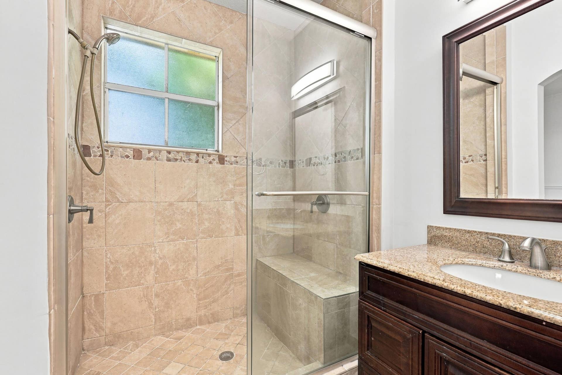 2107 Anchor Court, Fort Lauderdale, FL 33312 Private primary bathroom featuring a spacious walk in shower with floor to ceiling tile, frameless glass enclosure, built in bench, handheld showerhead, granite topped vanity, and a separate water closet.