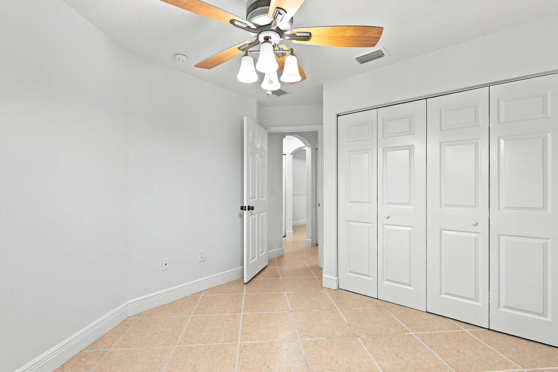 2107 Anchor Court, Fort Lauderdale, FL 33312 Spacious and versatile guest bedroom with tile flooring, ceiling fan, natural light, and generous closet space, also ideally suited for use as a private home office.
