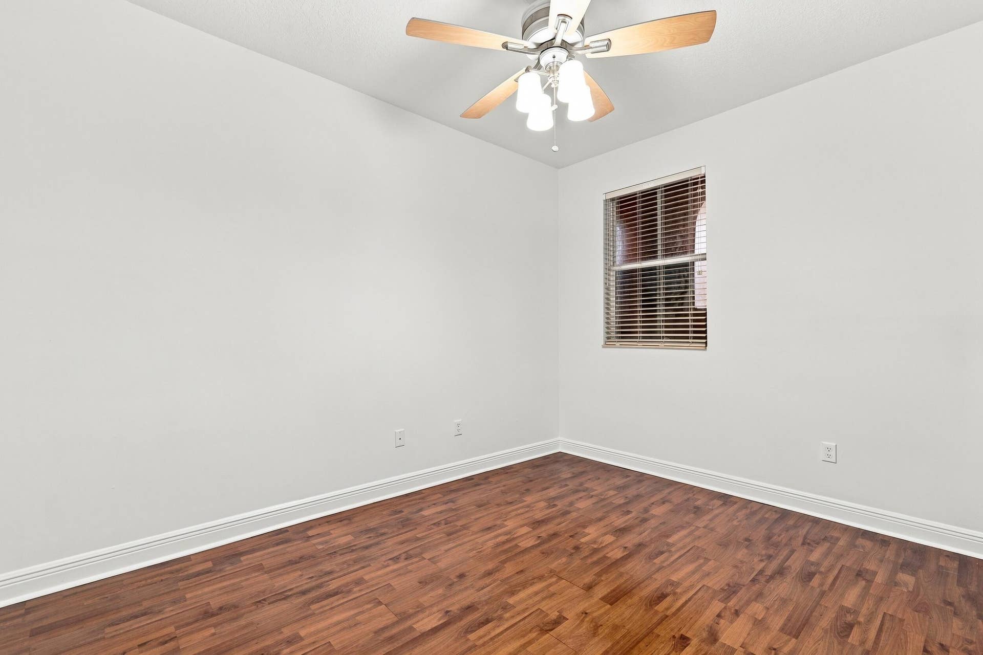 2107 Anchor Court, Fort Lauderdale, FL 33312 Spacious guest bedroom with wood flooring, ceiling fan, generous closet space, natural light, and a private ensuite full bathroom.