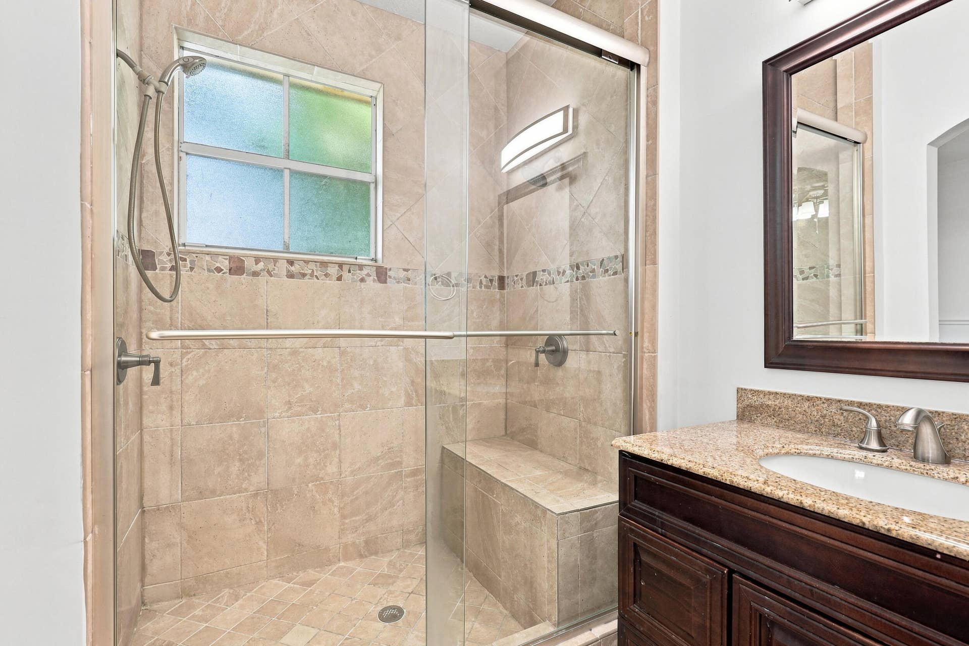 2107 Anchor Court, Fort Lauderdale, FL 33312 Private primary bathroom featuring a spacious walk in shower with floor to ceiling tile, frameless glass enclosure, built in bench, handheld showerhead, granite topped vanity, and a separate water closet.
