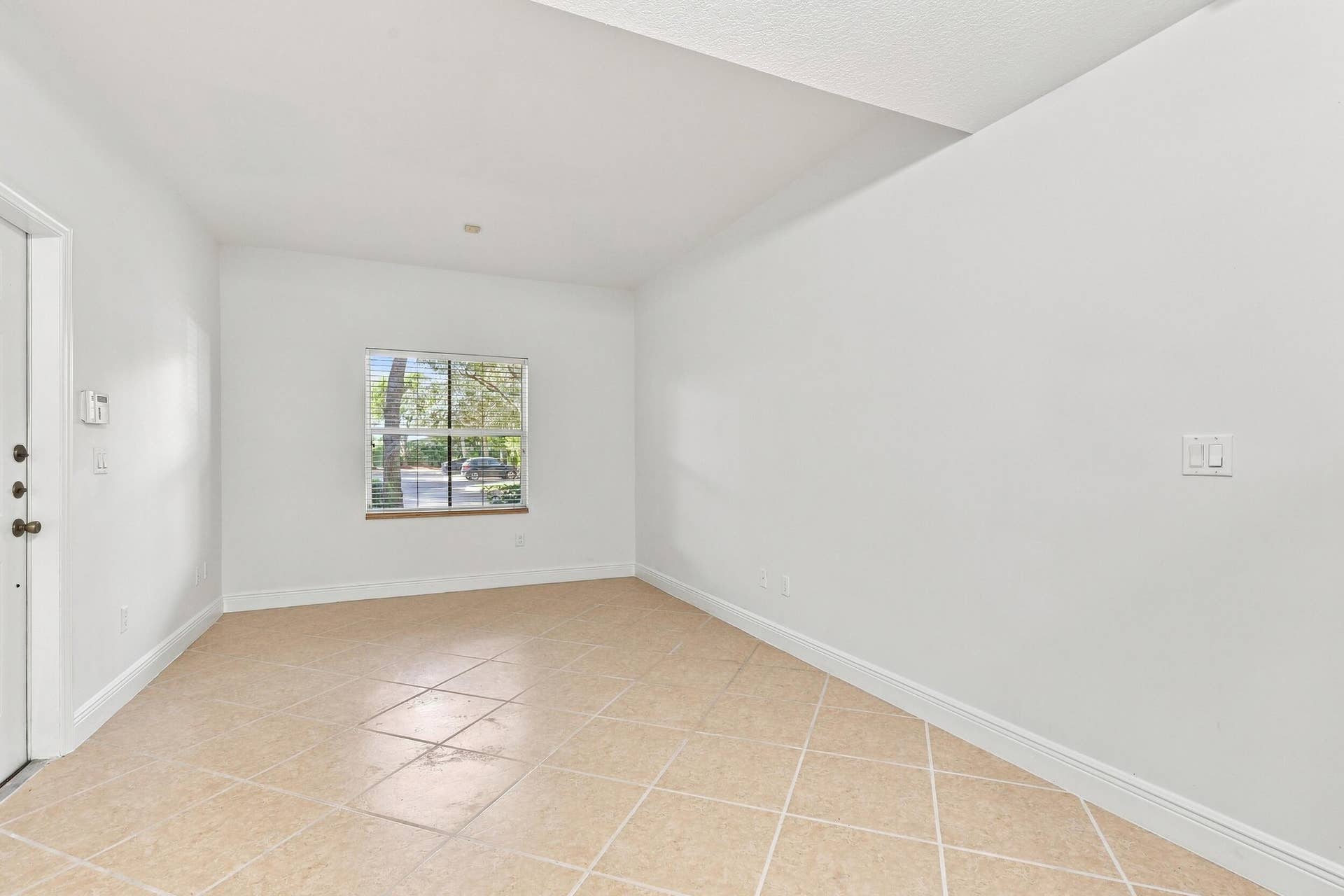 2107 Anchor Court, Fort Lauderdale, FL 33312 Spacious living room with tile flooring, high ceilings, abundant natural light, and an open layout that flows seamlessly into the dining area and kitchen.