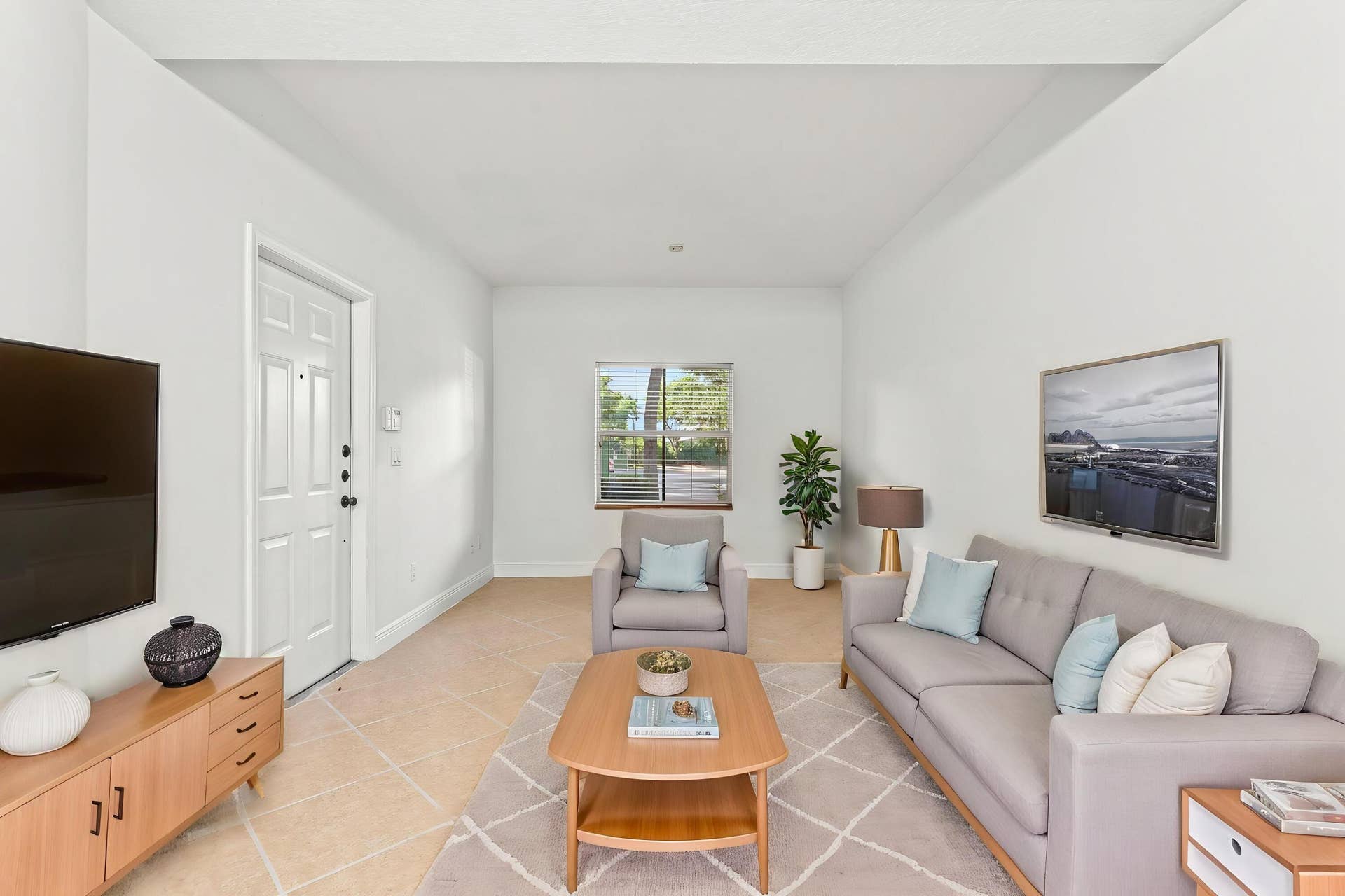 2107 Anchor Court, Fort Lauderdale, FL 33312 Spacious living room with tile flooring, high ceilings, abundant natural light, and an open layout that flows seamlessly into the dining area and kitchen.