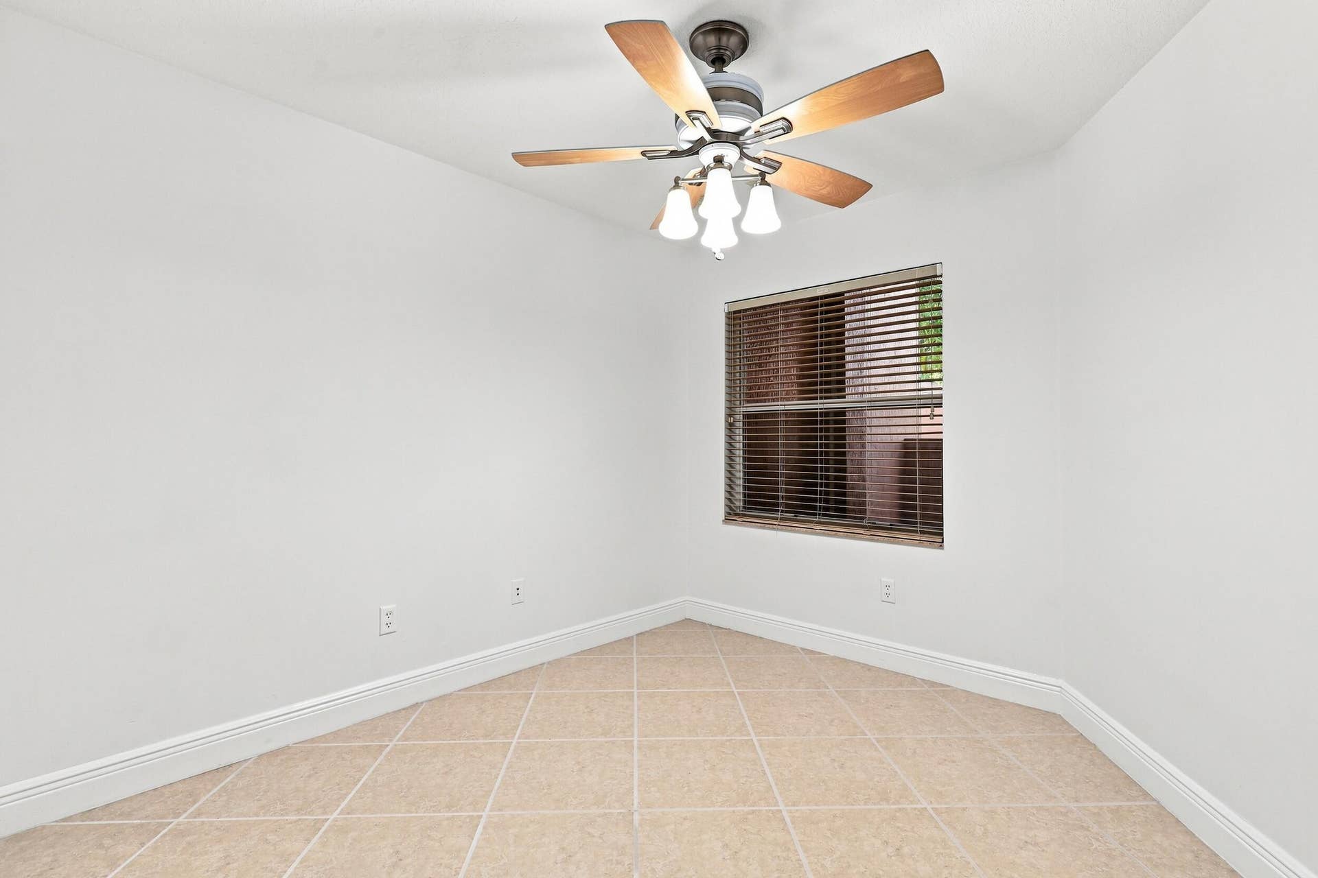 2107 Anchor Court, Fort Lauderdale, FL 33312 Spacious and versatile guest bedroom with tile flooring, ceiling fan, natural light, and generous closet space, also ideally suited for use as a private home office.